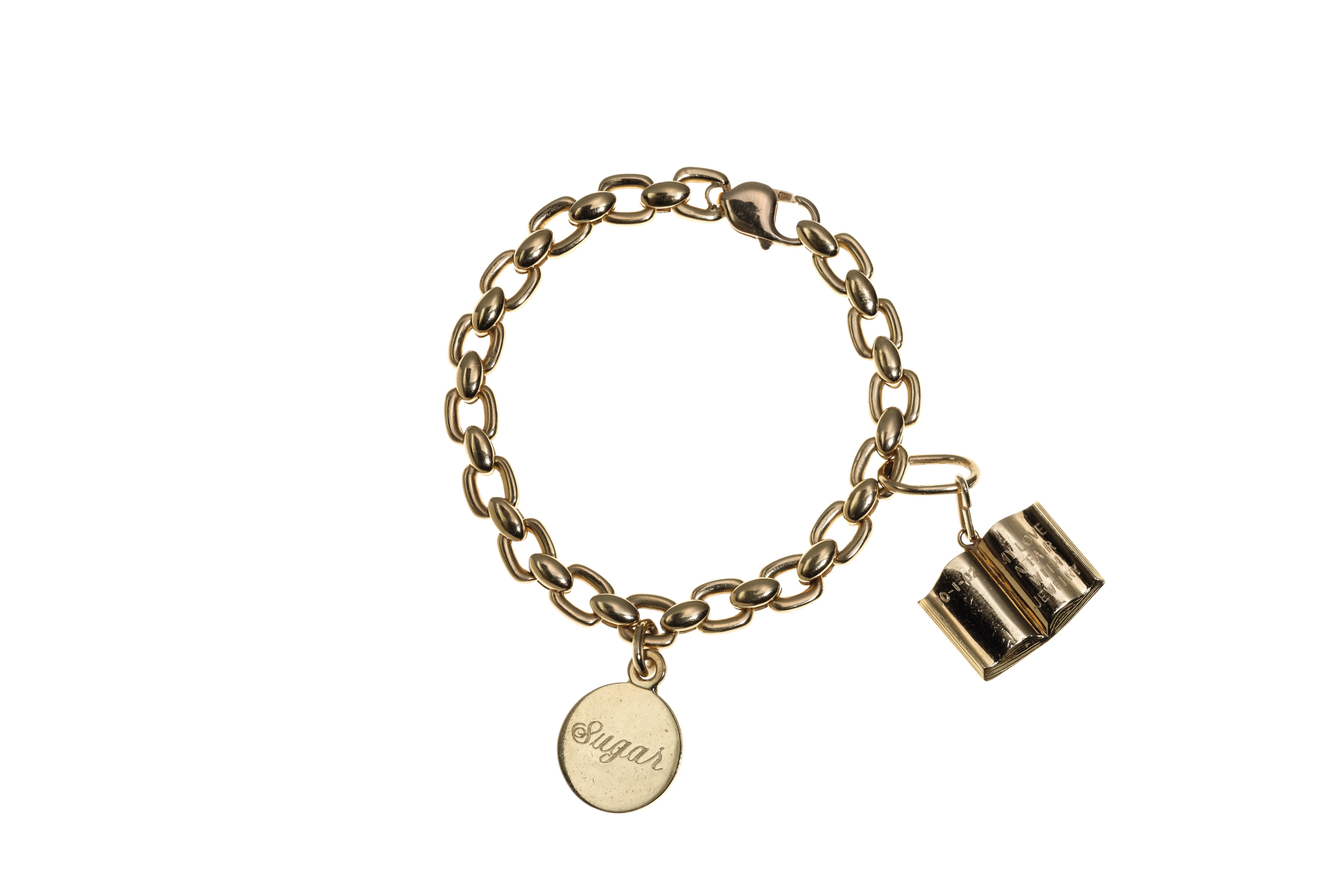 A GOLD CHARM BRACELET | Christie's