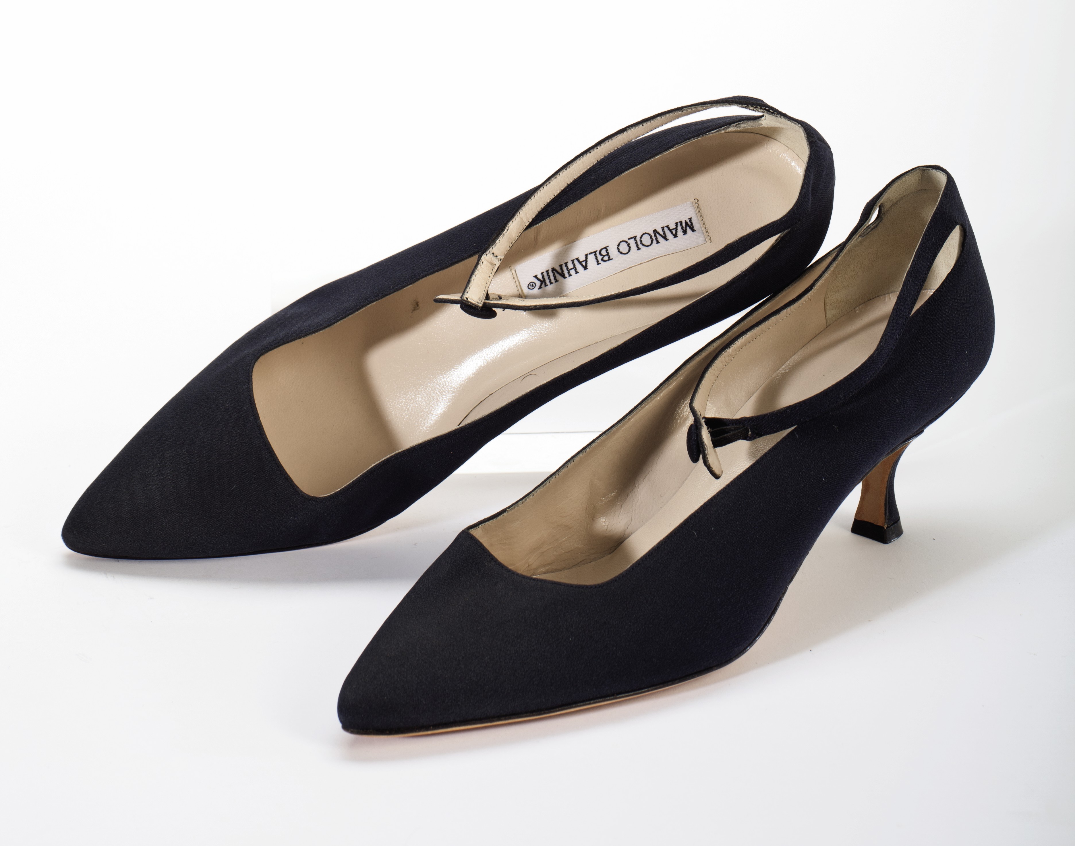 A PAIR OF BLACK SILK ANKLE STRAP KITTEN HEELS , LABELED 'MANOLO BLAHNIK' Christie's
