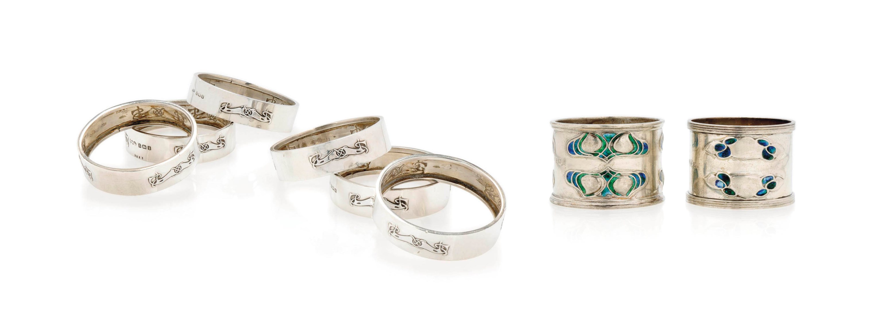 A SET OF SIX ARCHIBALD KNOX FOR LIBERTY & CO SILVER NAPKIN RINGS , 1909