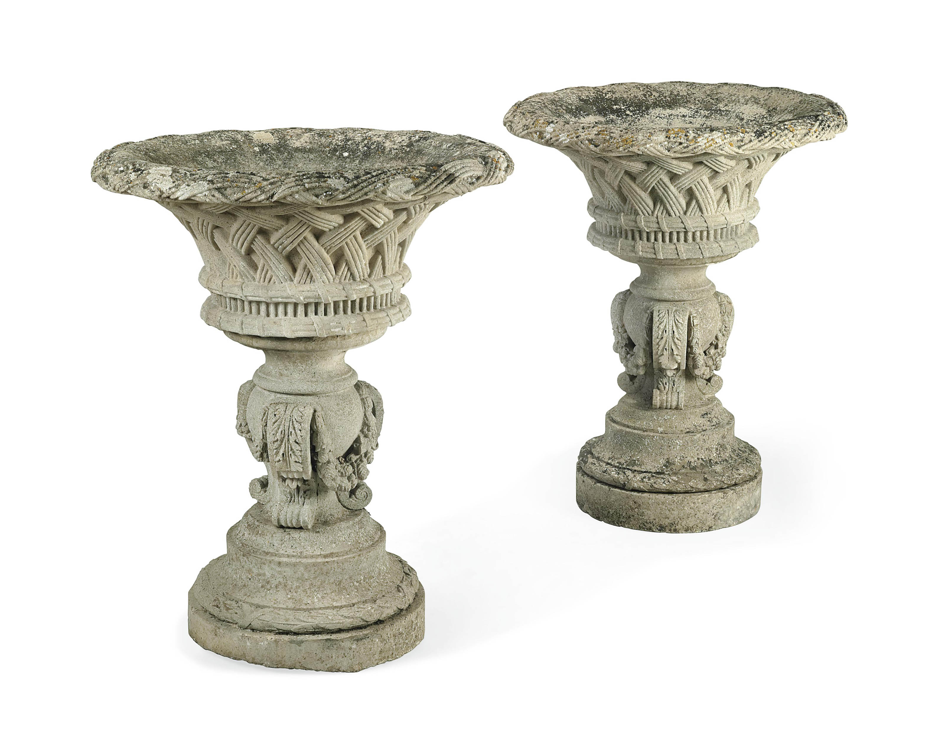 A LARGE PAIR OF COMPOSITION STONE GARDEN URNS AND PEDESTALS , ATTRIBUTED TO AUSTIN AND SEELEY