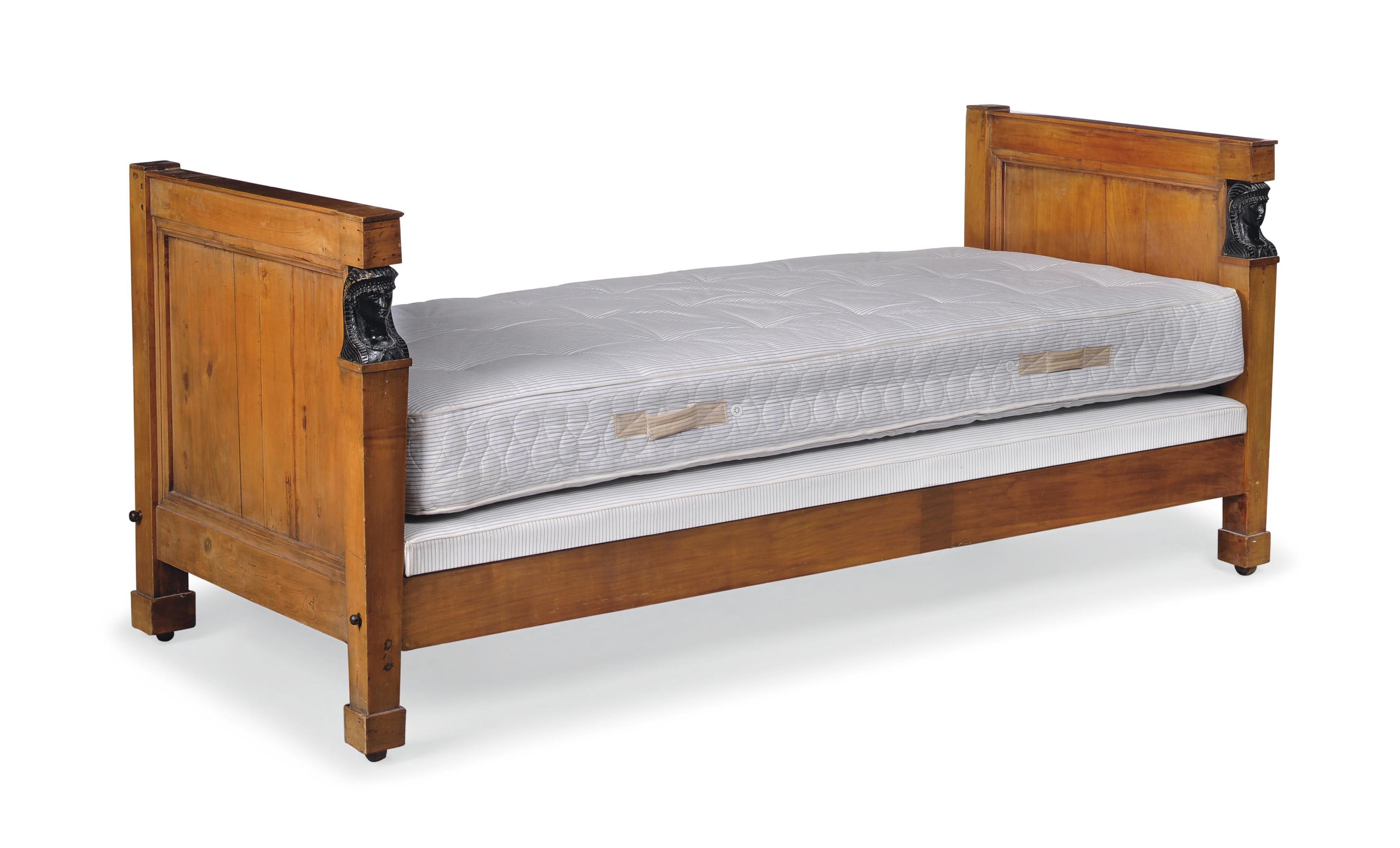 A GERMAN BIEDERMEIER FRUITWOOD AND EBONISED BED , EARLY 19TH CENTURY
