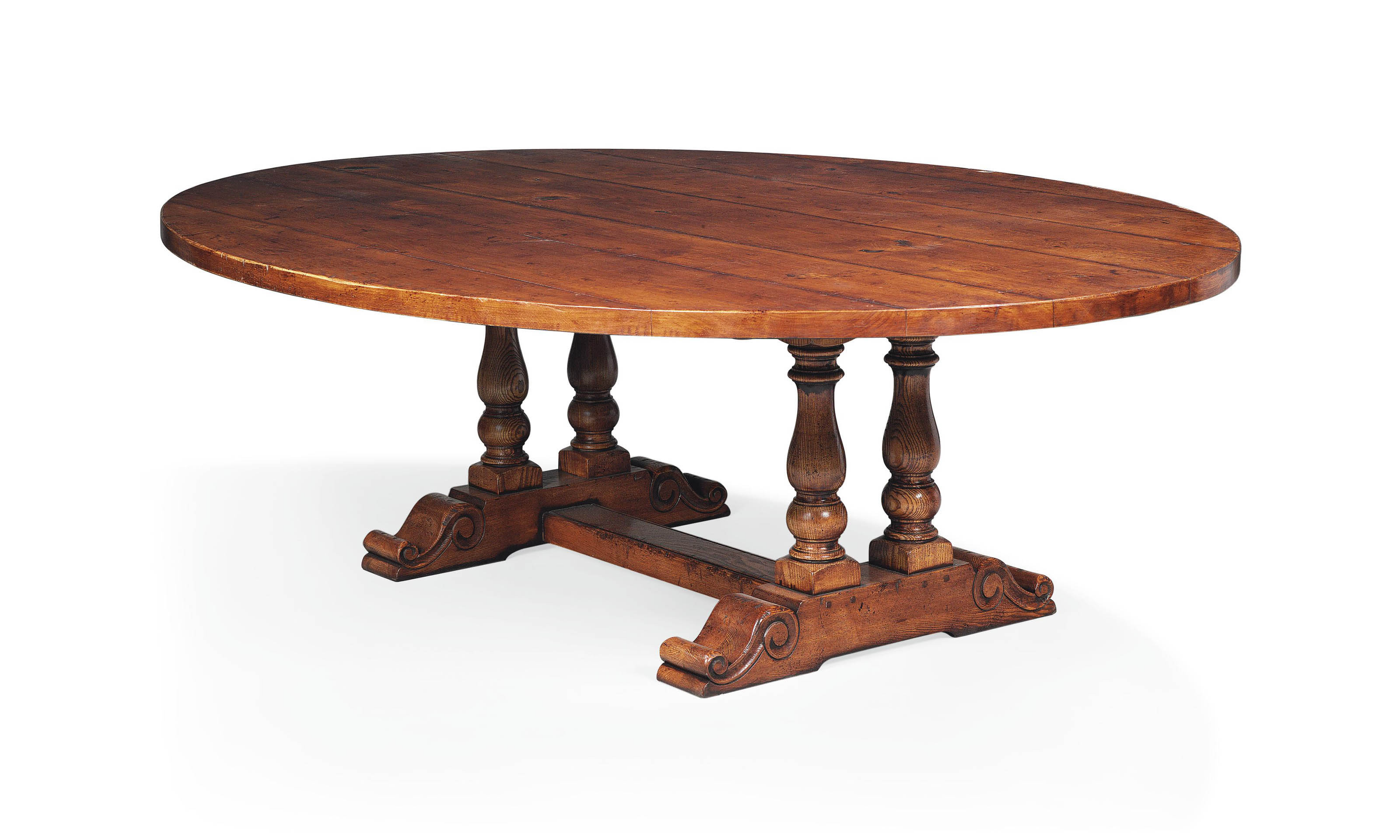 A LARGE OAK OVAL DINING TABLE