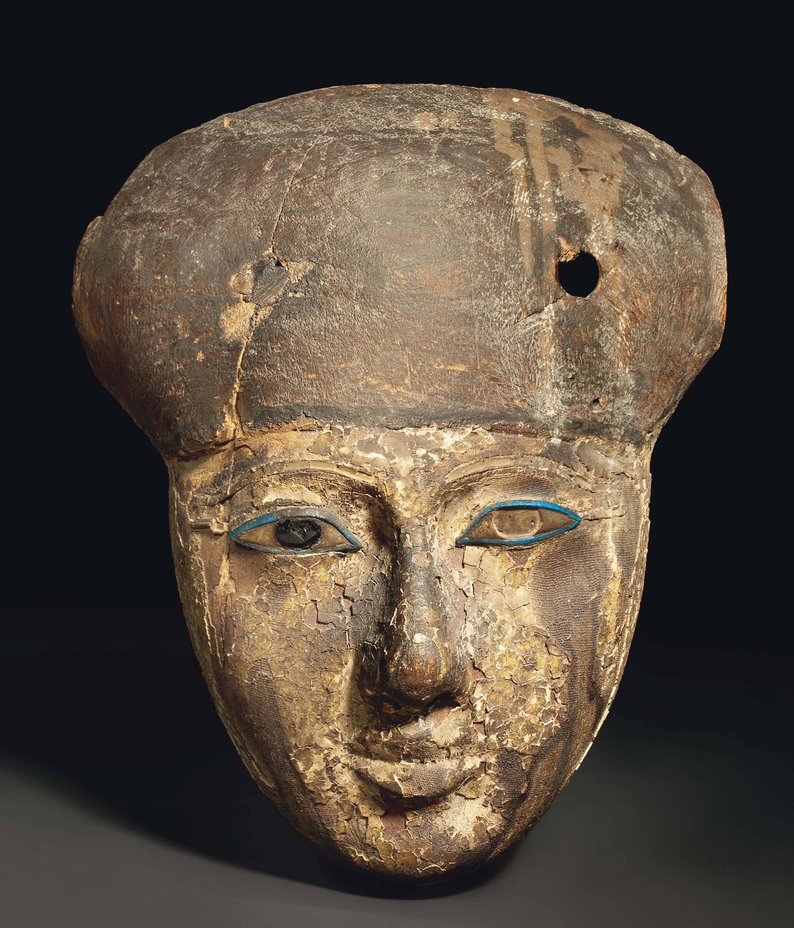AN EGYPTIAN WOOD MUMMY MASK , THIRD INTERMEDIATE PERIOD, DYNASTY XXI