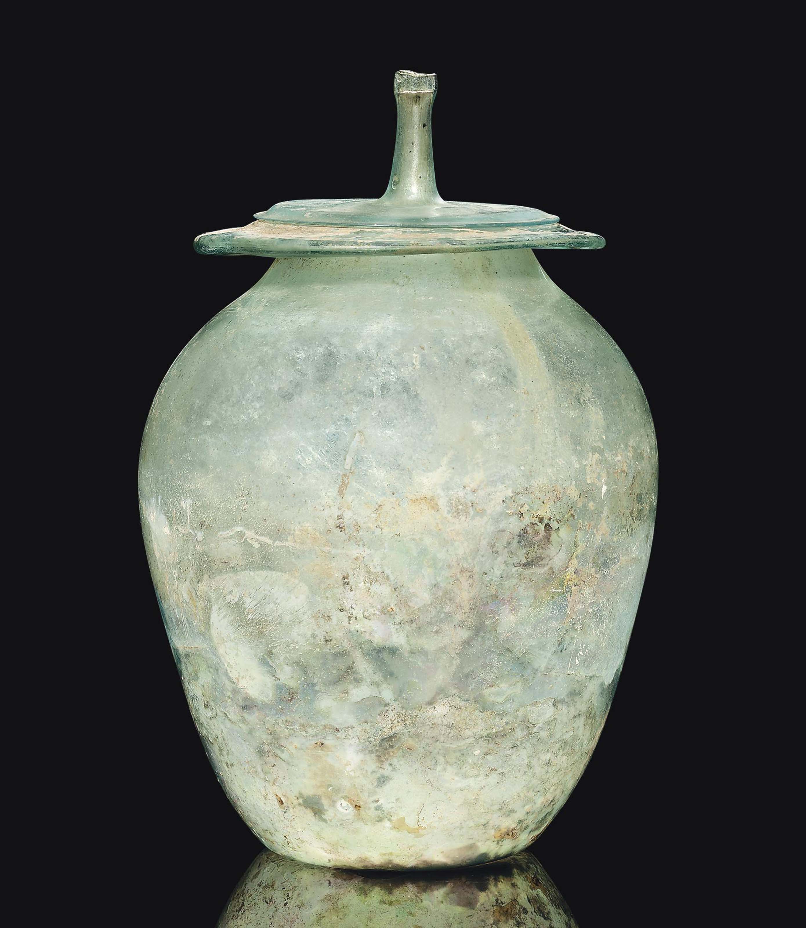 A ROMAN GREEN GLASS CINERARY URN , CIRCA 1ST2ND CENTURY A.D. Christie's