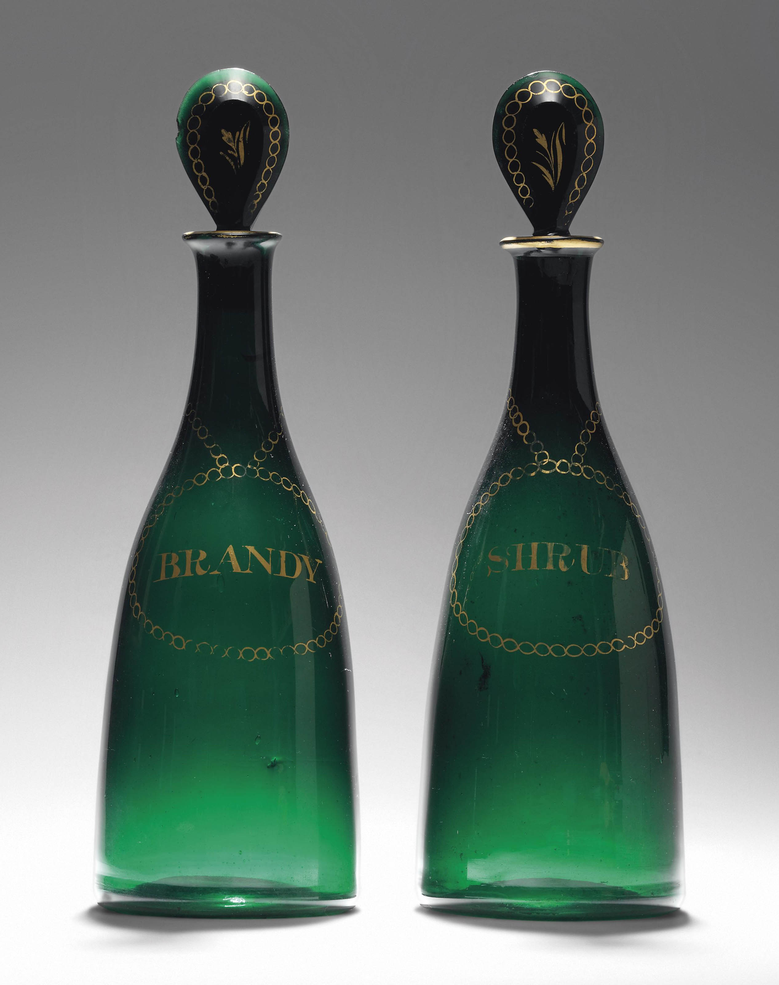 A PAIR OF GREEN GLASS DECANTERS AND STOPPERS , CIRCA 1800 Christie's