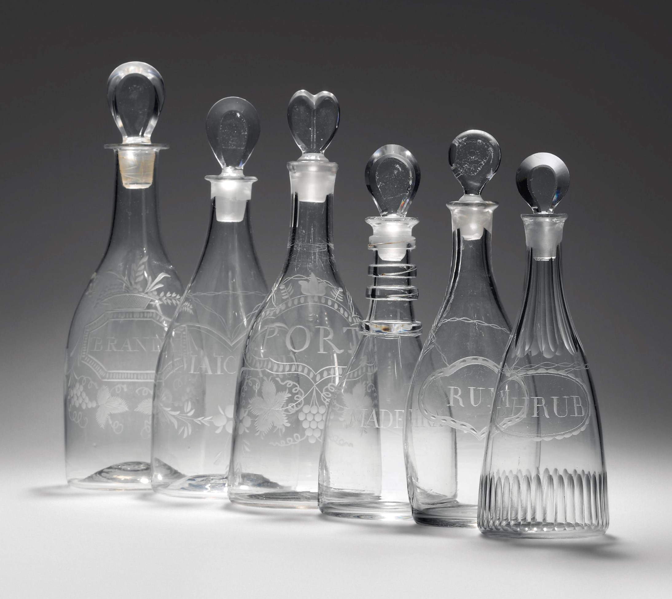 SIX ENGLISH ENGRAVED GLASS DECANTERS AND STOPPERS , LATE 18TH CENTURY