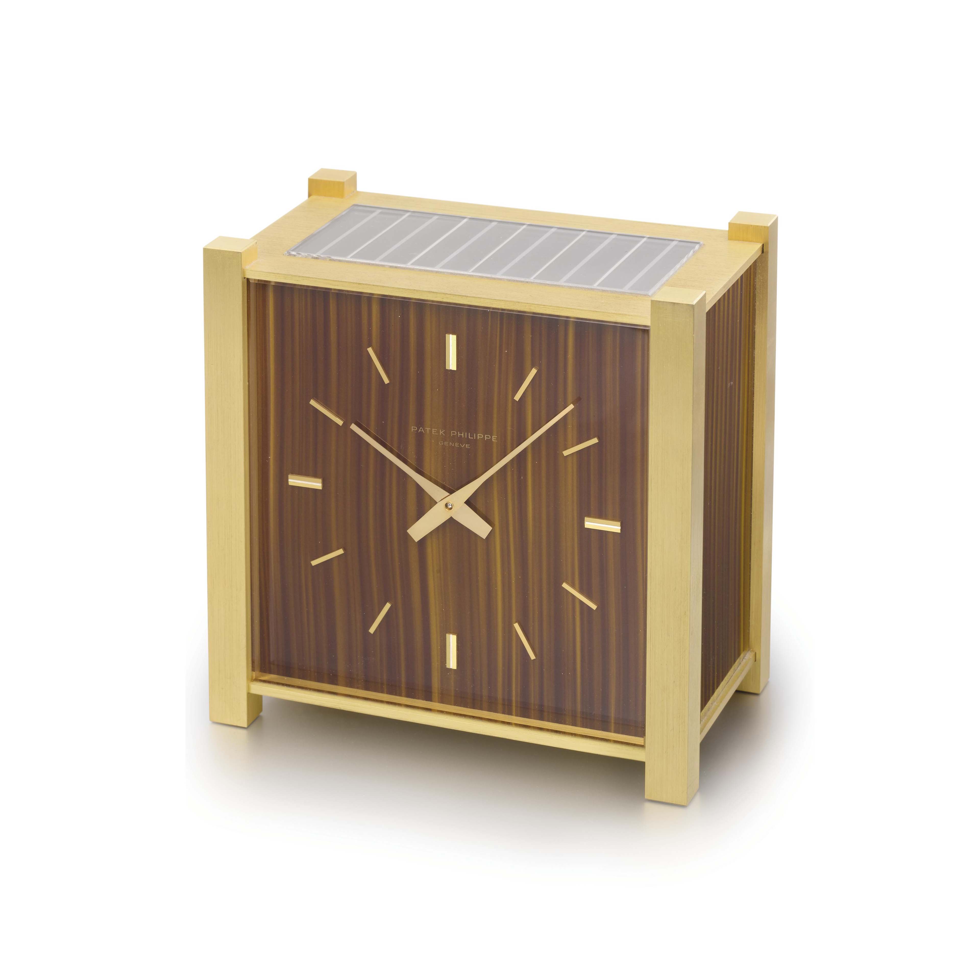Patek Philippe. An unusual gilt brass square solarpowered desk clock