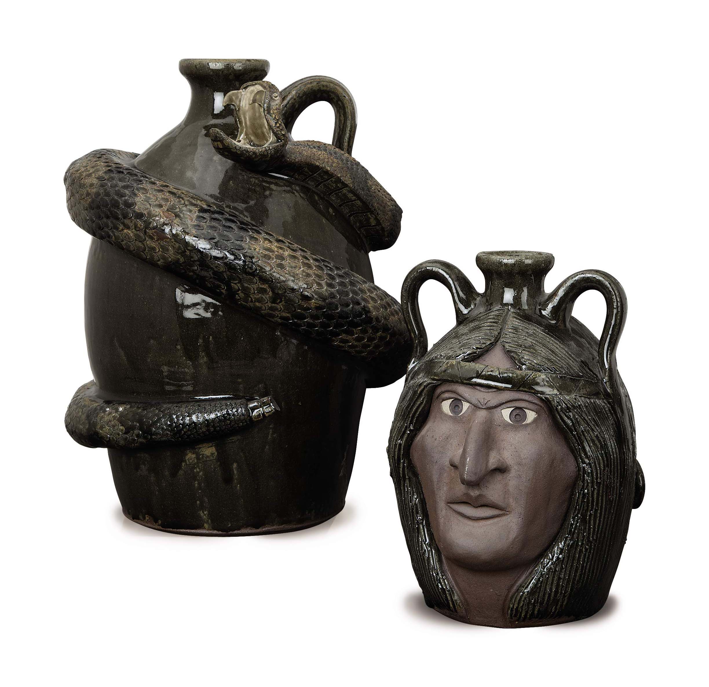 FOUR AMERICAN GLAZED EARTHENWARE 'SNAKE JUGS' AND A DOUBLE 'FACE JUG