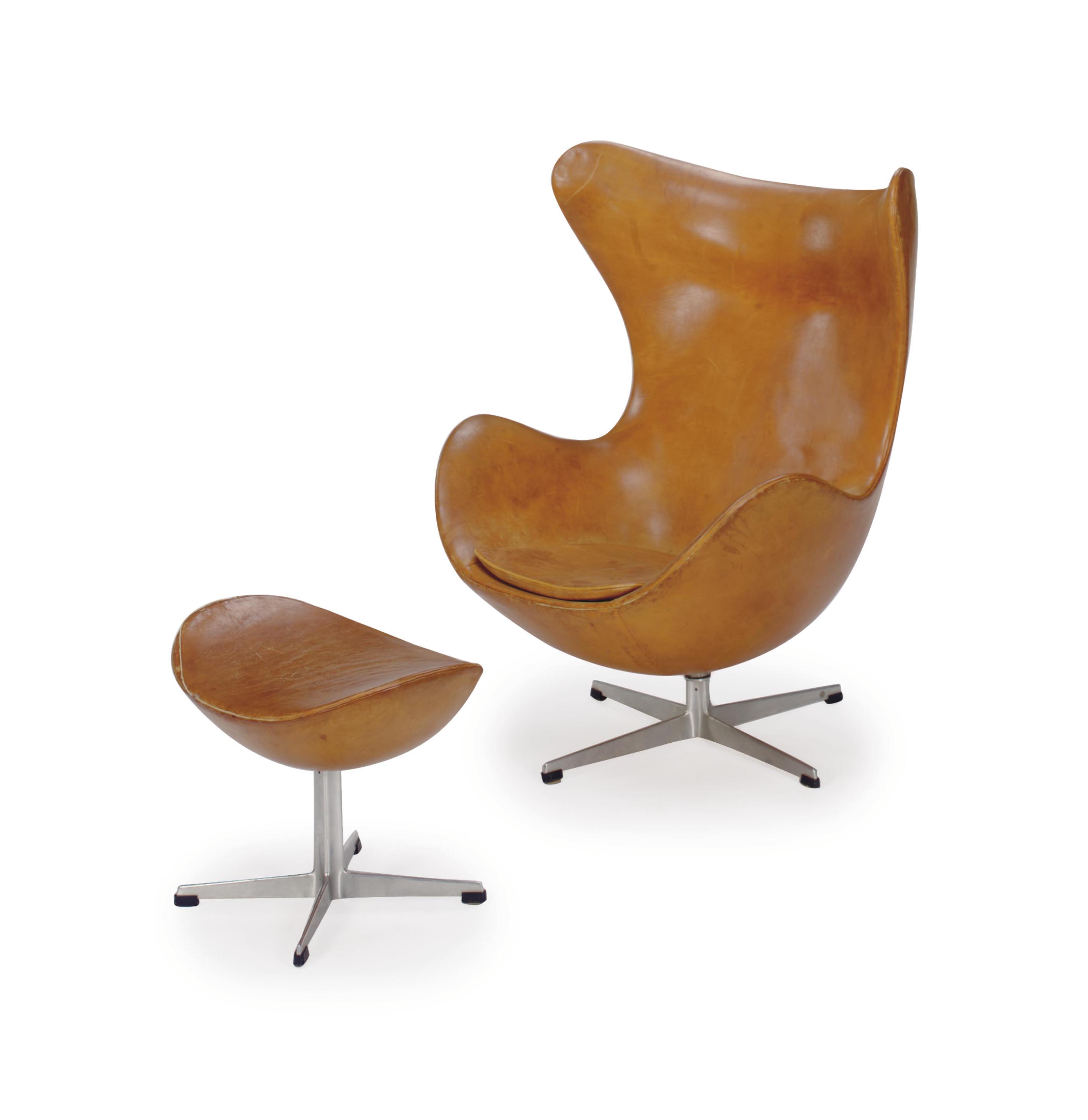 AN ALUMINUM AND LEATHER UPHOLSTERED 'EGG' LOUNGE CHAIR AND OTTOMAN