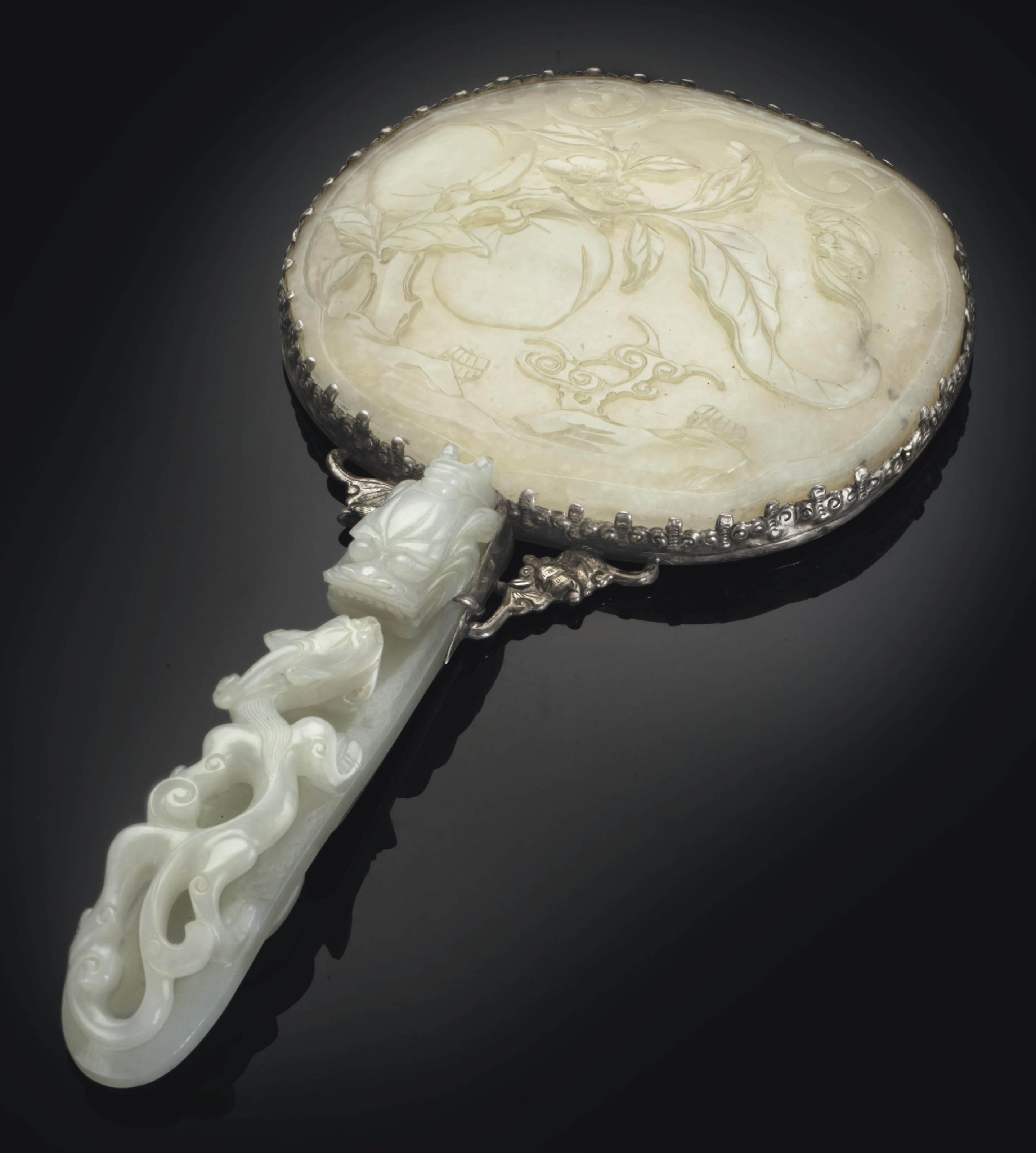 A WHITE JADEMOUNTED SILVER HAND MIRROR , THE JADE ELEMENTS, 18TH