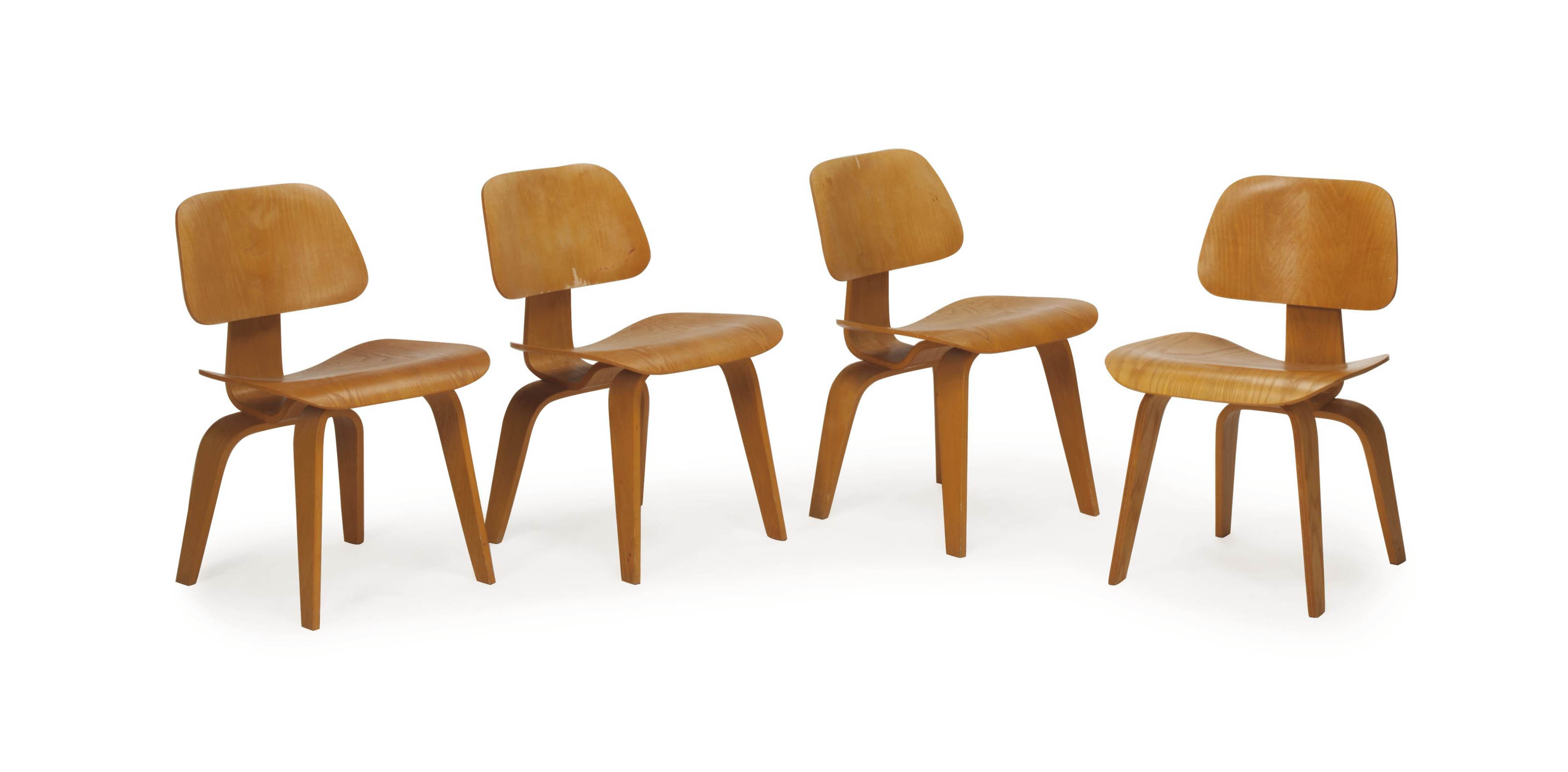 A SET OF FOUR LAMINATED OAK 'LCW' CHAIRS, , DESIGNED BY CHARLES AND RAY