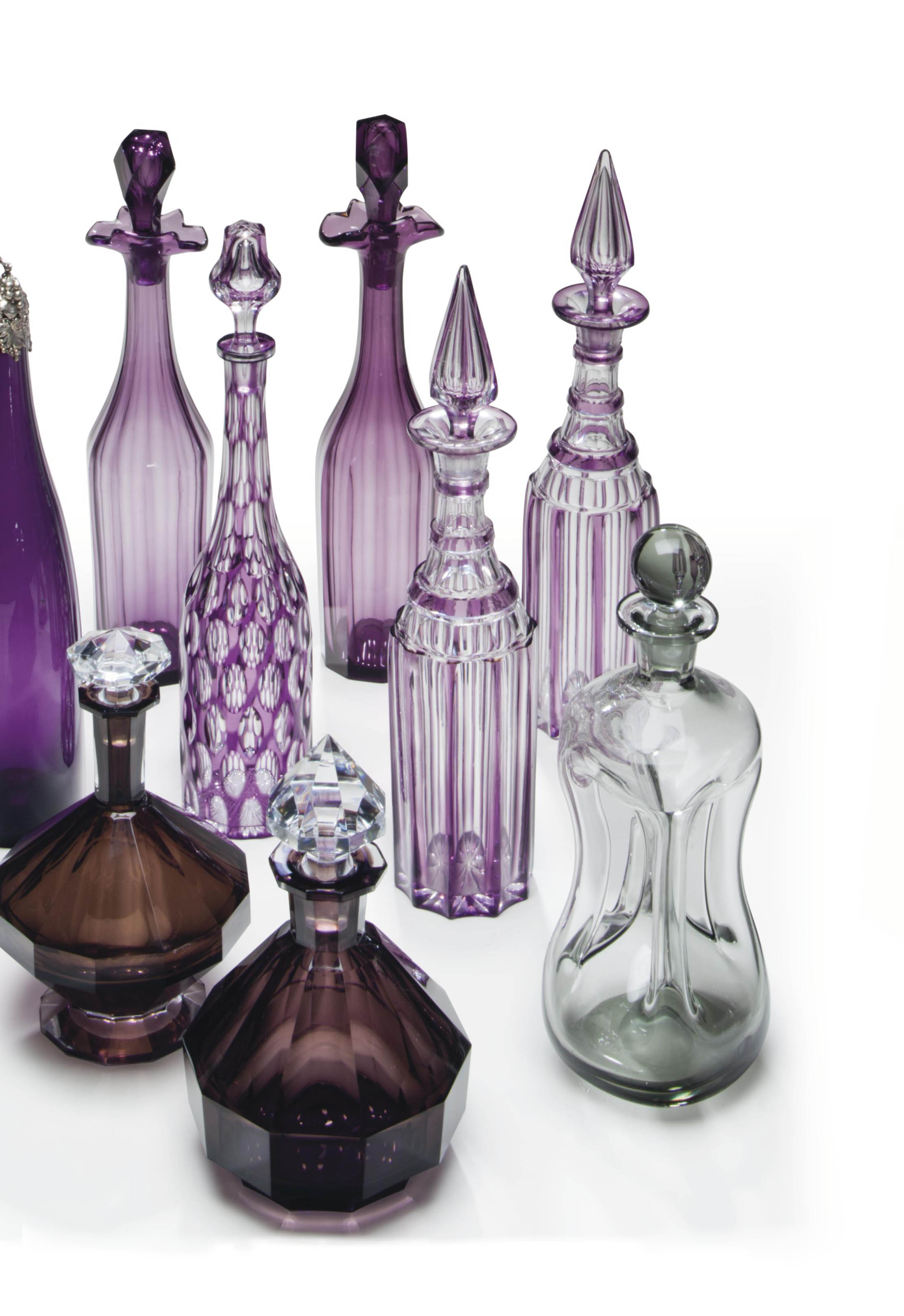 A COLLECTION OF NINE AMETHYST GLASS DECANTERS AND STOPPERS , 19TH/20TH