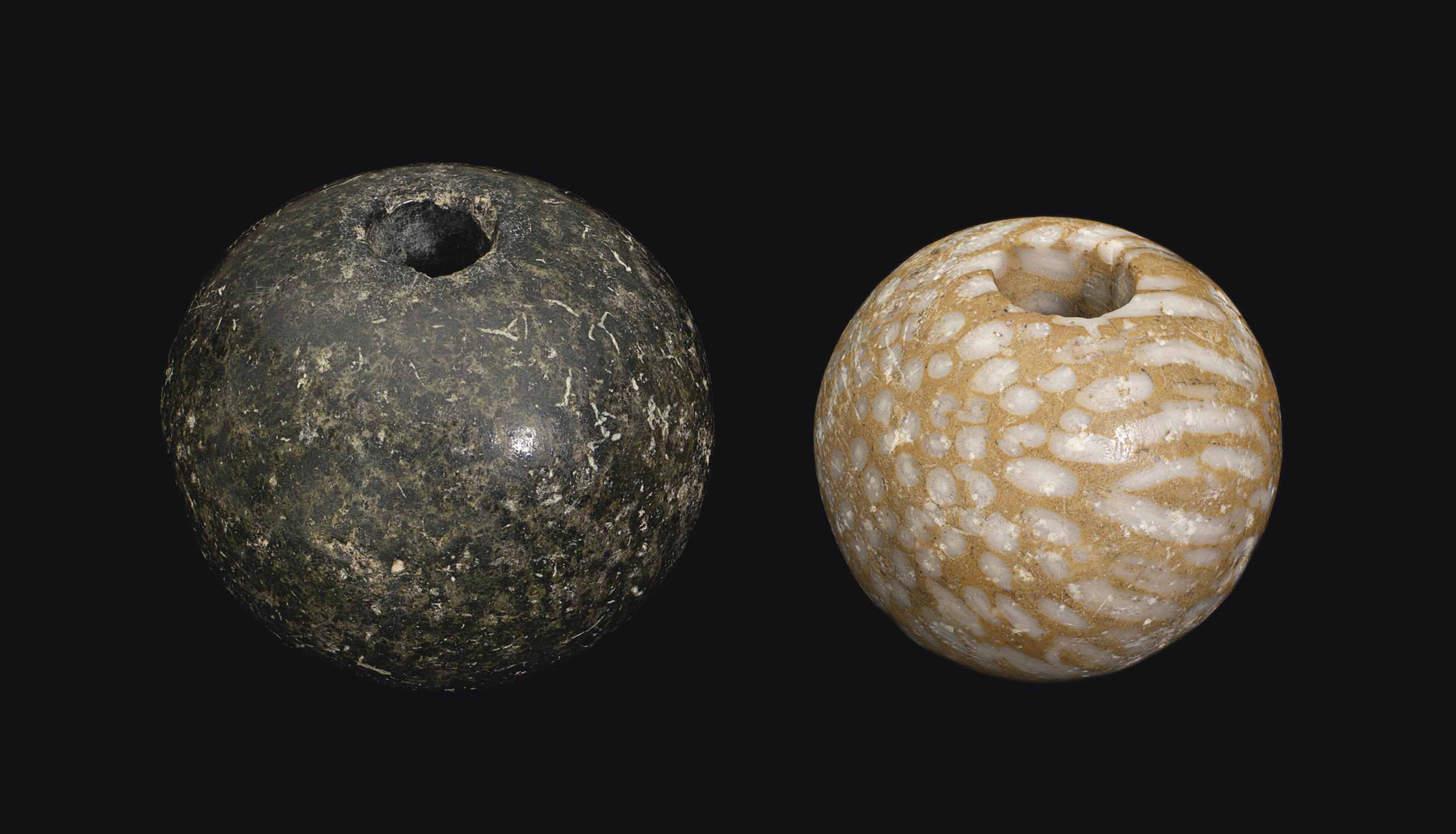 TWO EGYPTIAN STONE MACE HEADS , PREDYNASTIC PERIOD, CIRCA 3200 B.C