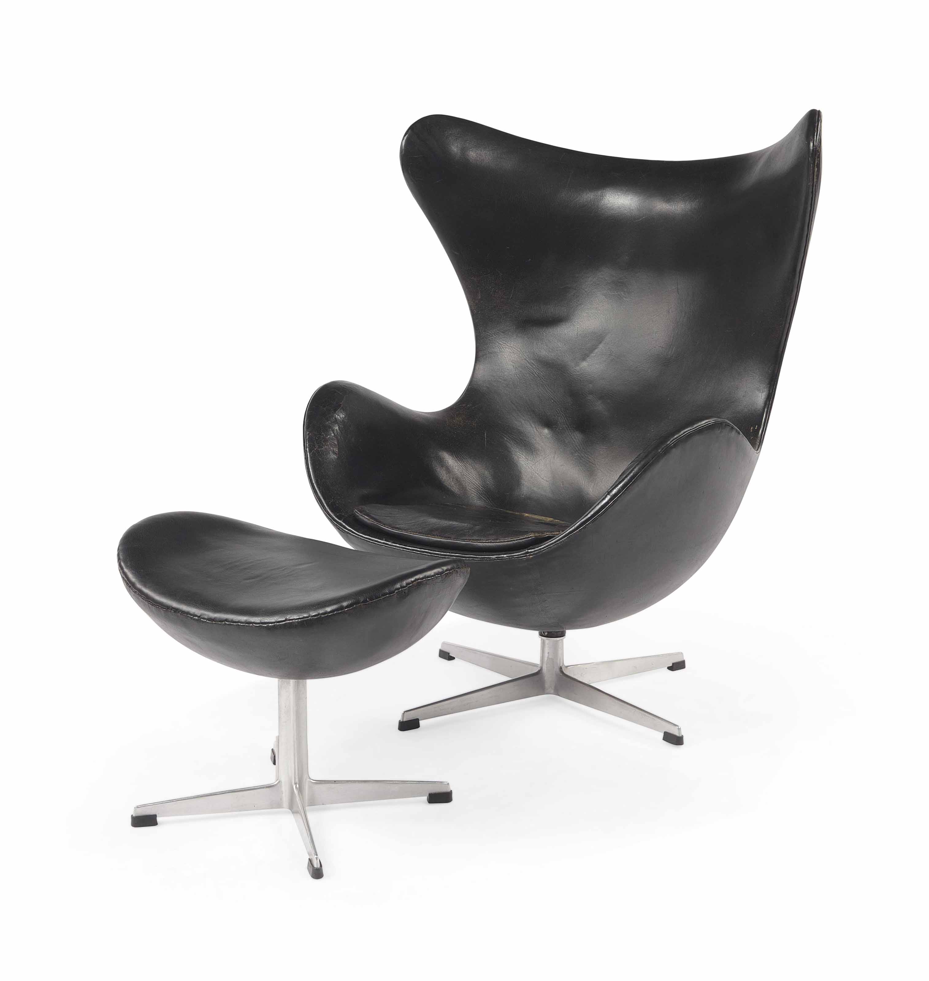 An aluminium and leather upholstered 'egg chair' and foor stool, model