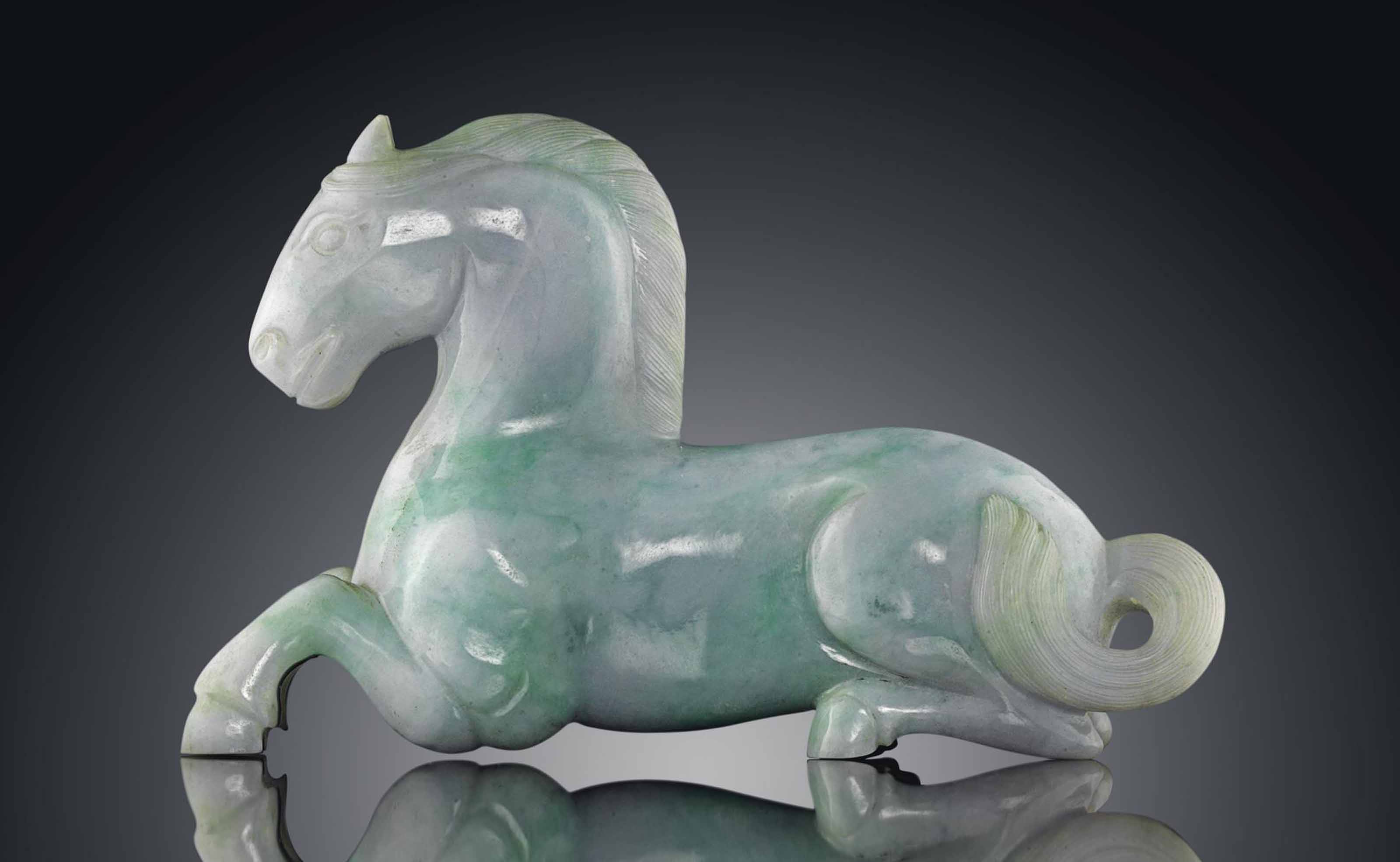 AN APPLE AND PALE GREEN JADEITE CARVING OF A HORSE Christie's