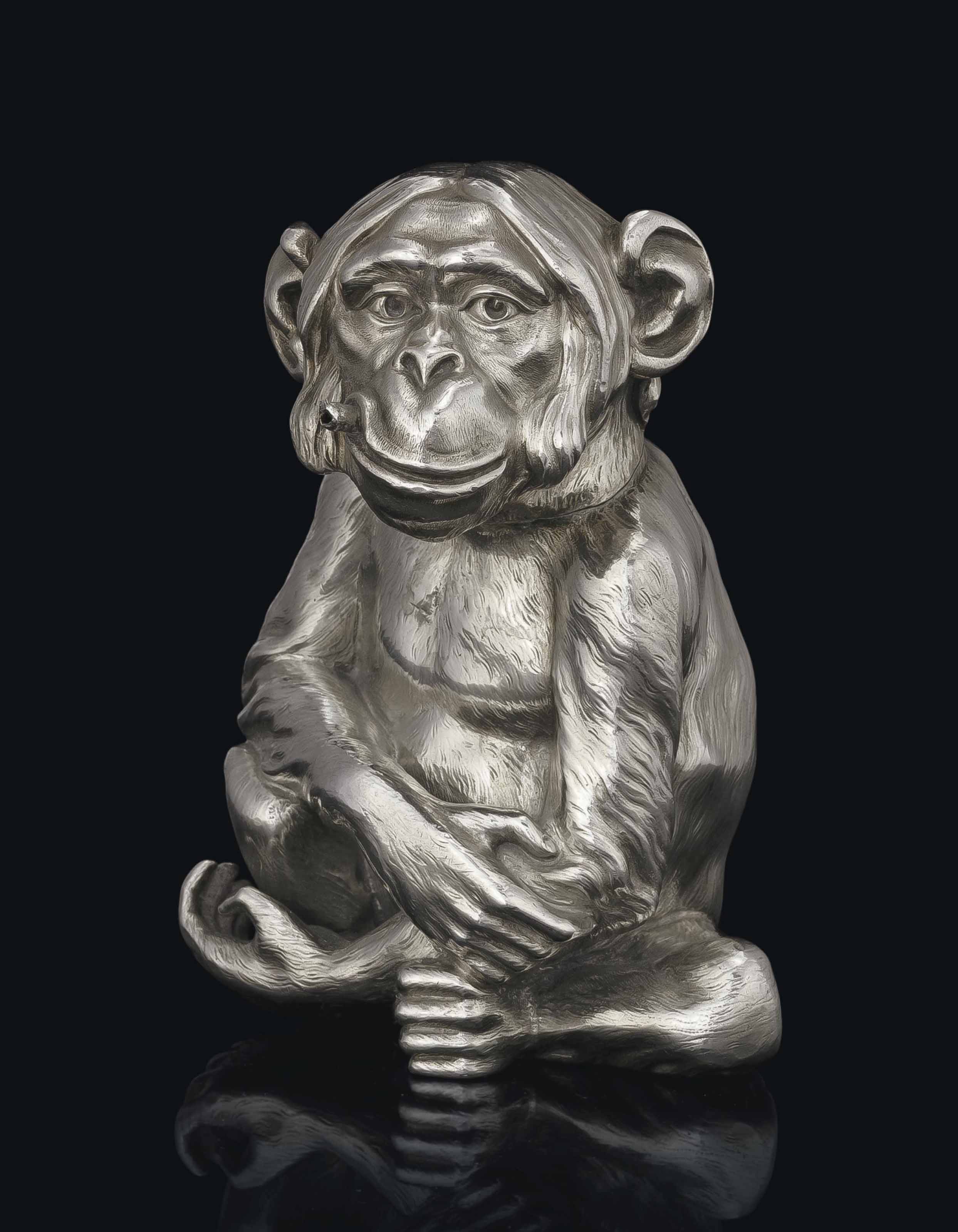 A SILVER TABLE LIGHTER IN THE FORM OF A SMOKING MONKEY , MARKED FABERGÉ  WITH THE IMPERIAL WARRANT, WITH THE WORKMASTER'S MARK OF JULIUS RAPPOPORT,  ST PETERSBURG, 1899-1908, SCRATCHED INVENTORY NUMBER 3165 | Christie's