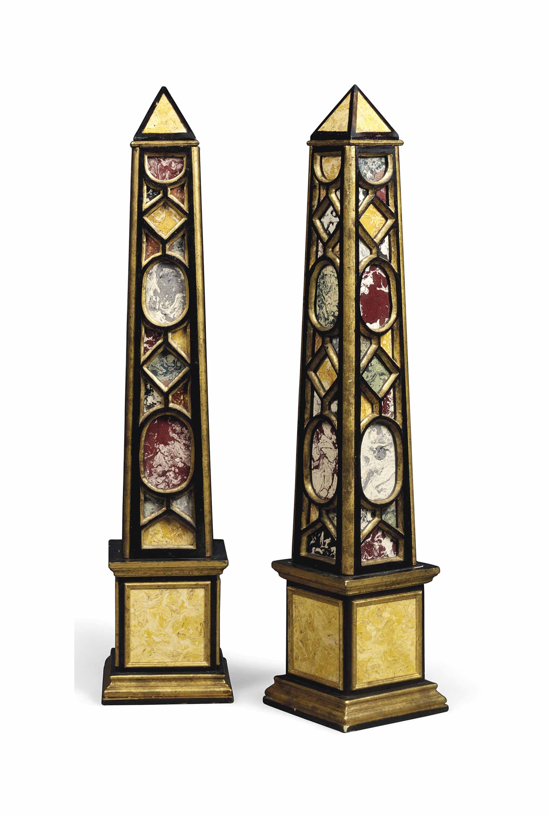 A PAIR OF POLYCHROMEDECORATED EBONISED AND SIMULATED MARBLE OBELISKS