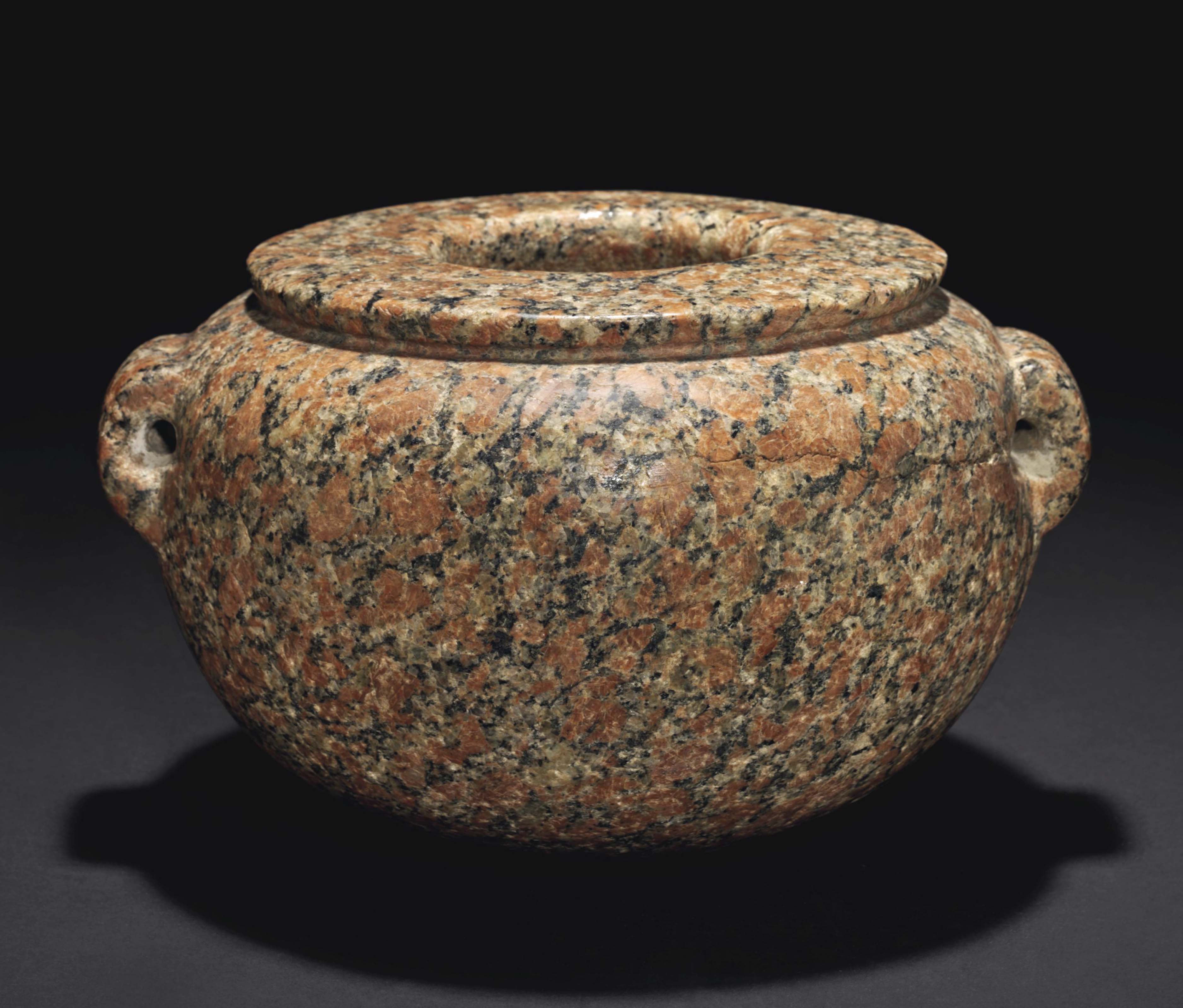 AN EGYPTIAN RED GRANITE JAR