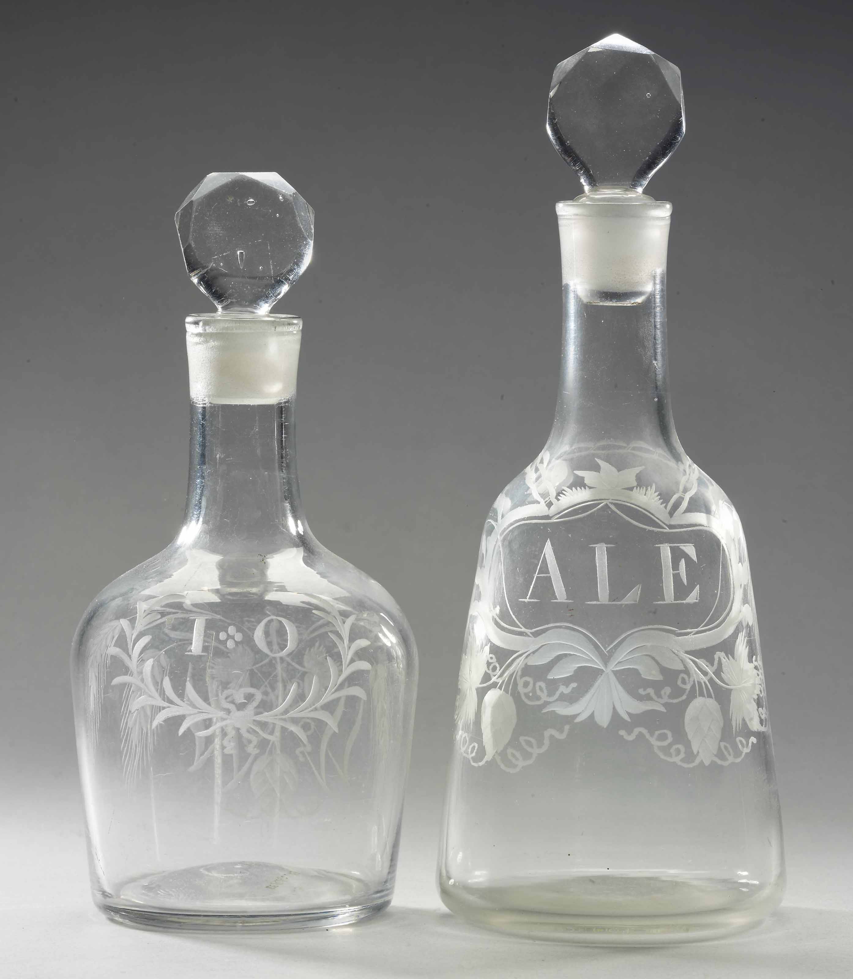 TWO ENGLISH ENGRAVED GLASS DECANTERS AND STOPPERS AND A LARGE ENGRAVED