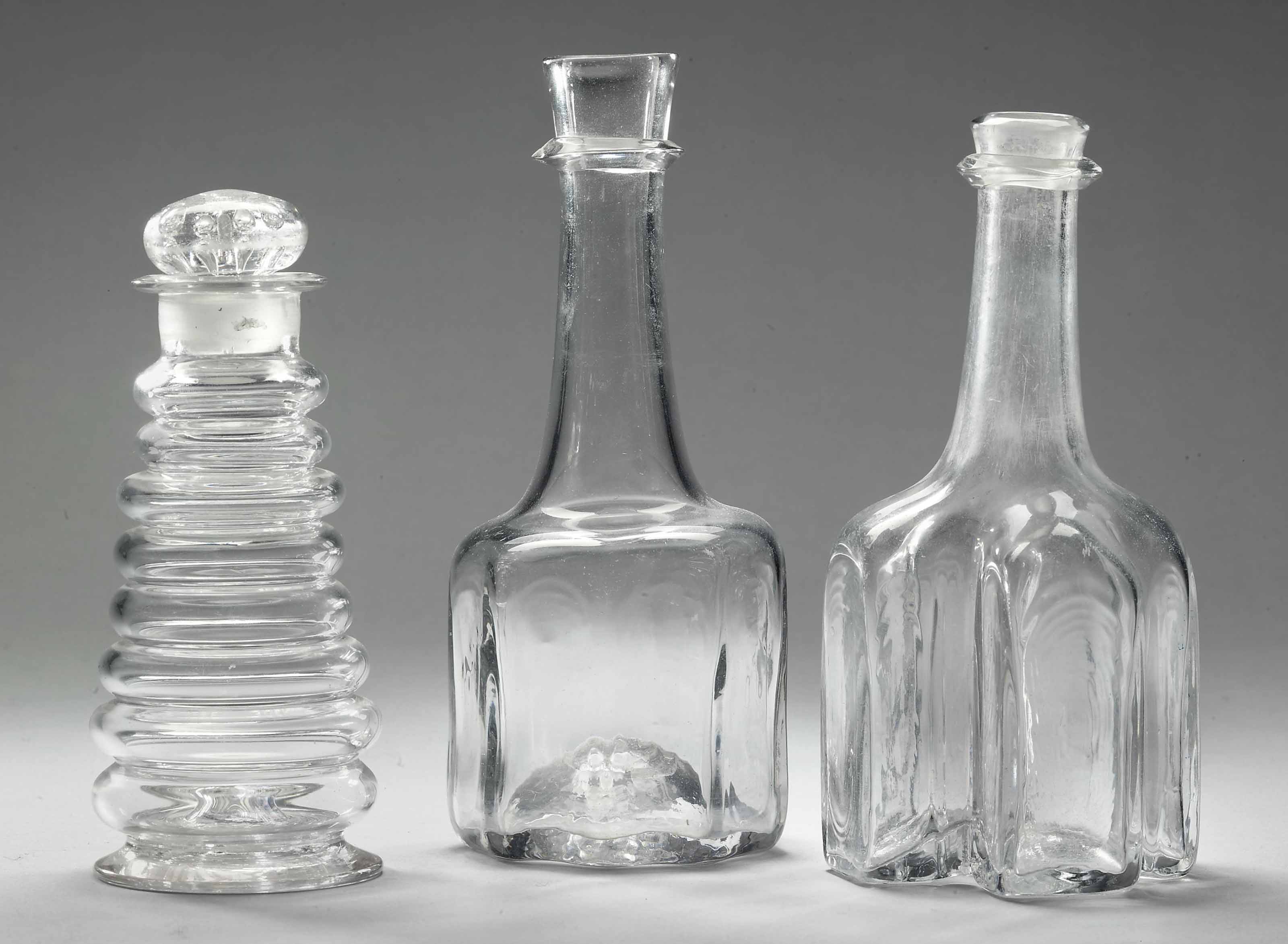 AN ENGLISH GLASS CARAFE, ANOTHER AND A DECANTER AND STOPPER , 18TH