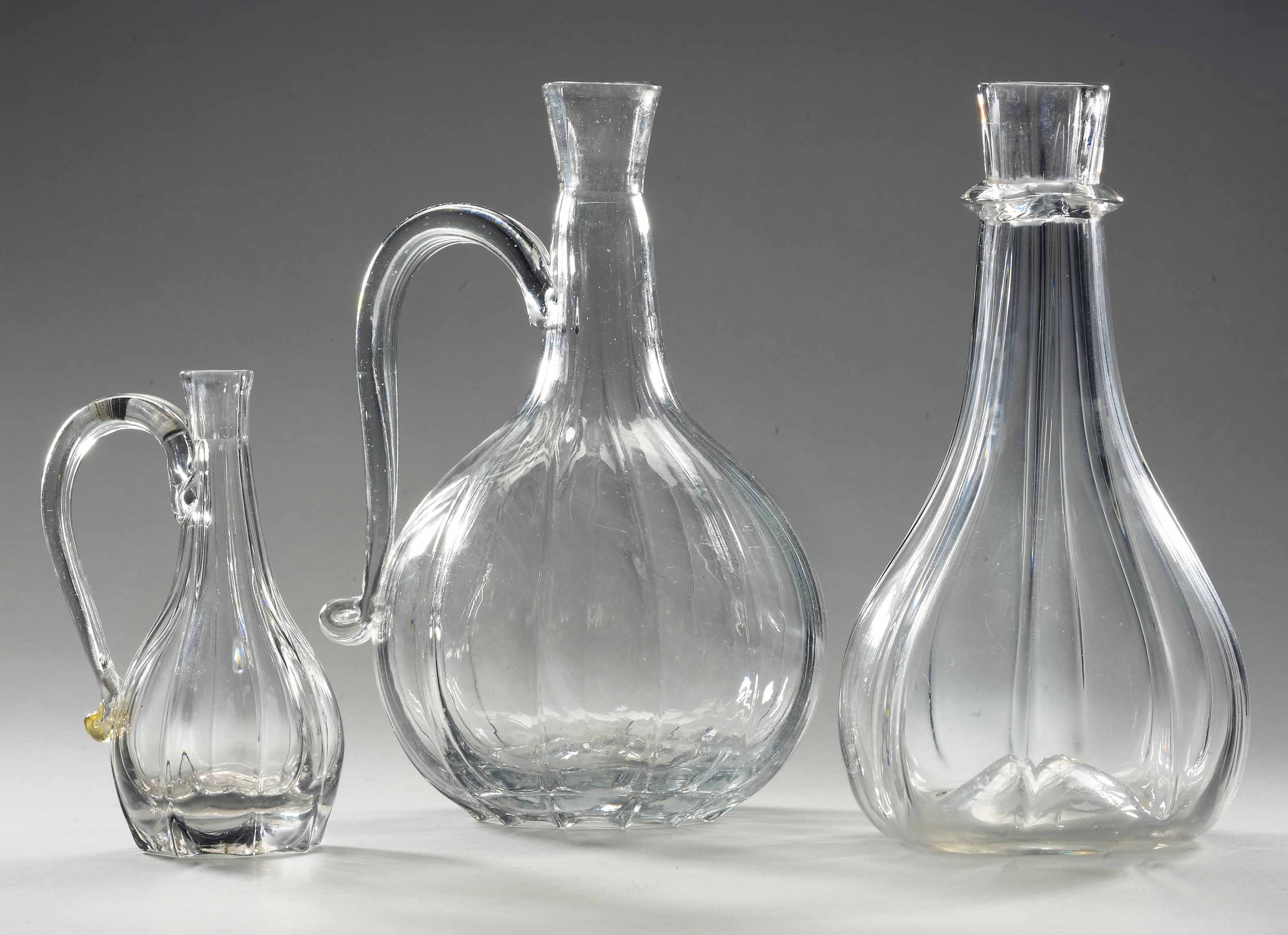 AN ENGLISH GLASS CARAFE OR GUGLET AND TWO JUGS , ALL 18TH CENTURY
