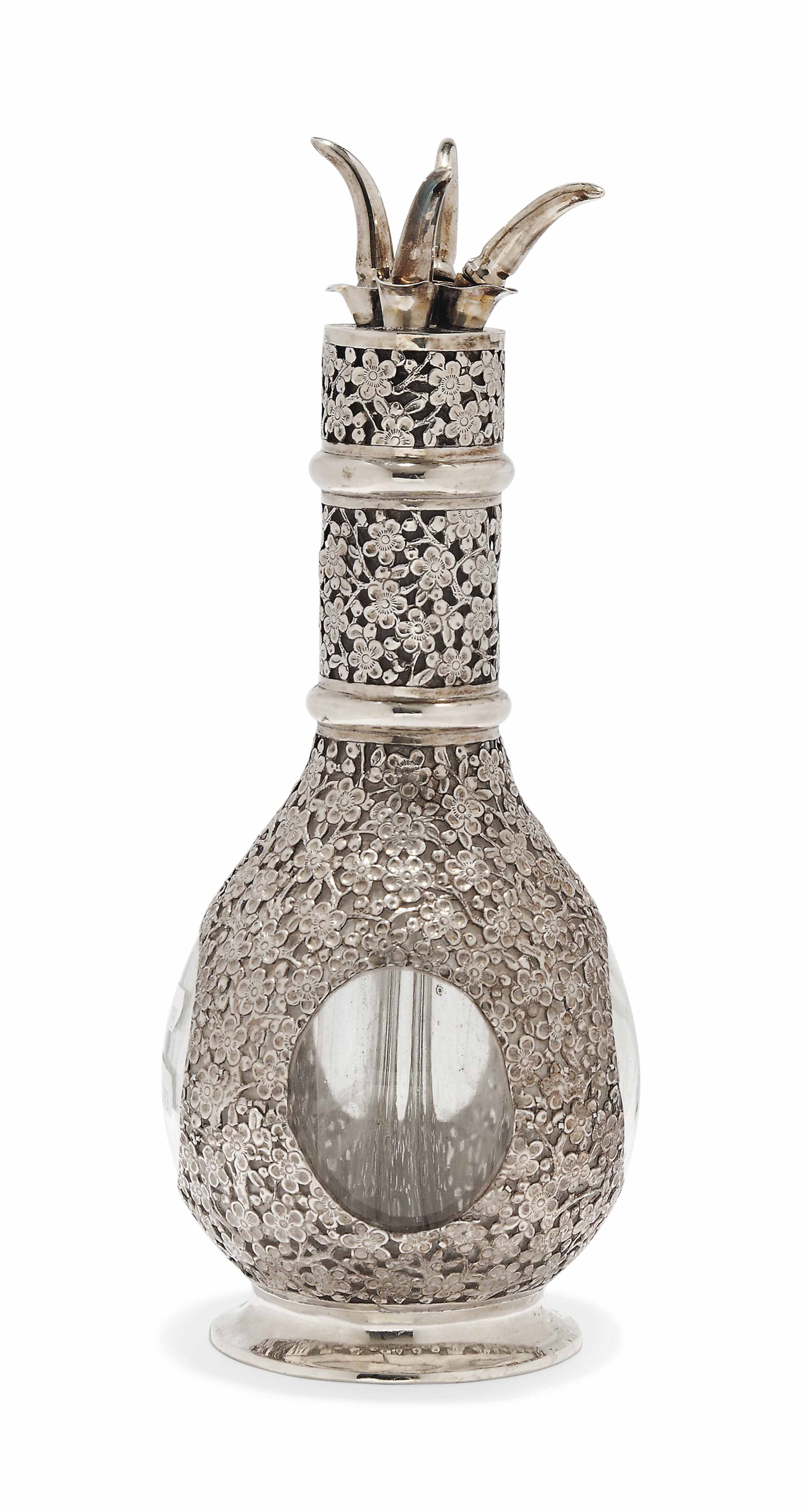A CHINESE METALWAREMOUNTED GLASS SPIRIT DECANTER WITH FOUR