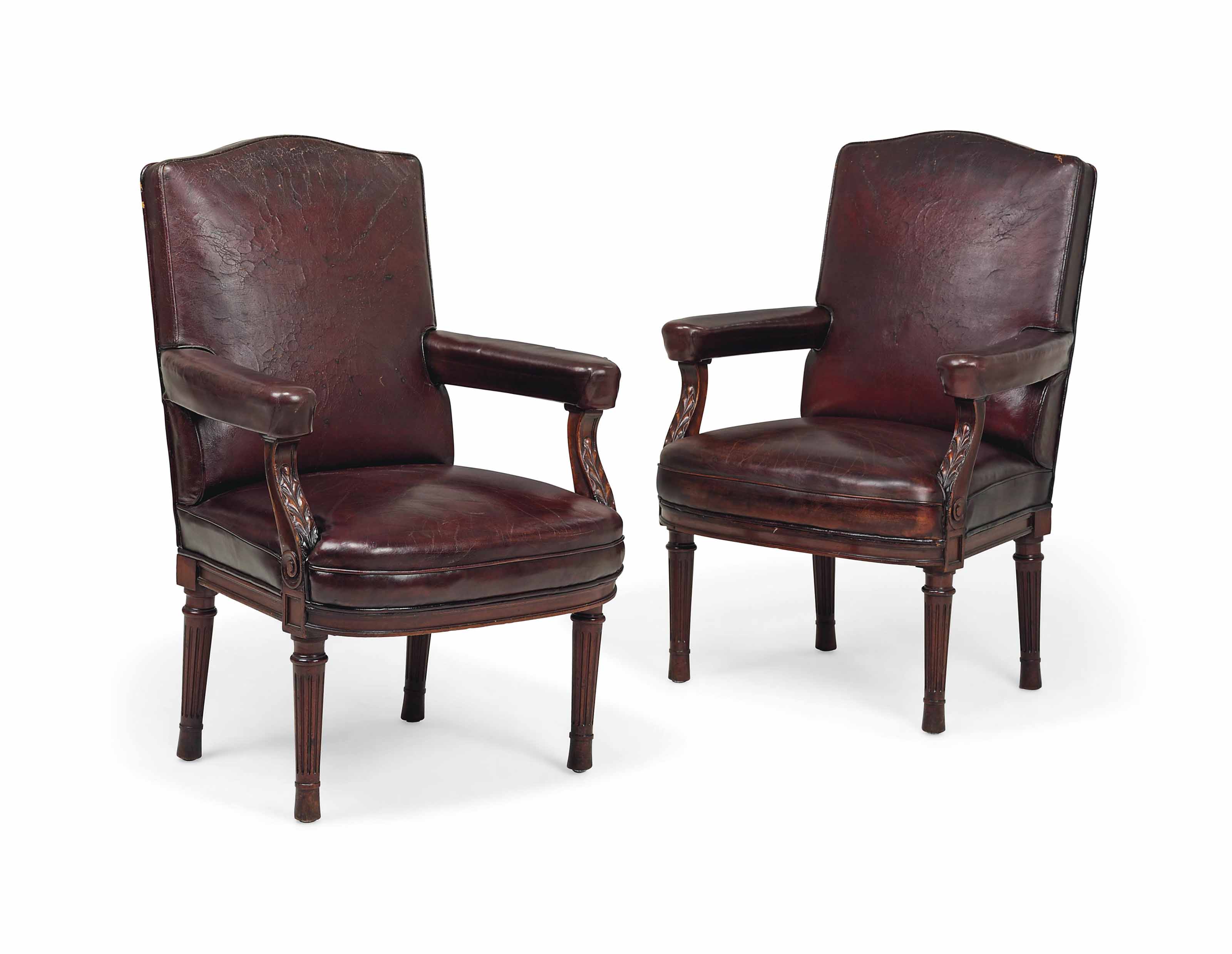 A PAIR OF LEATHER COVERED MAHOGANY ARMCHAIRS , LATE 19TH/EARLY 20TH