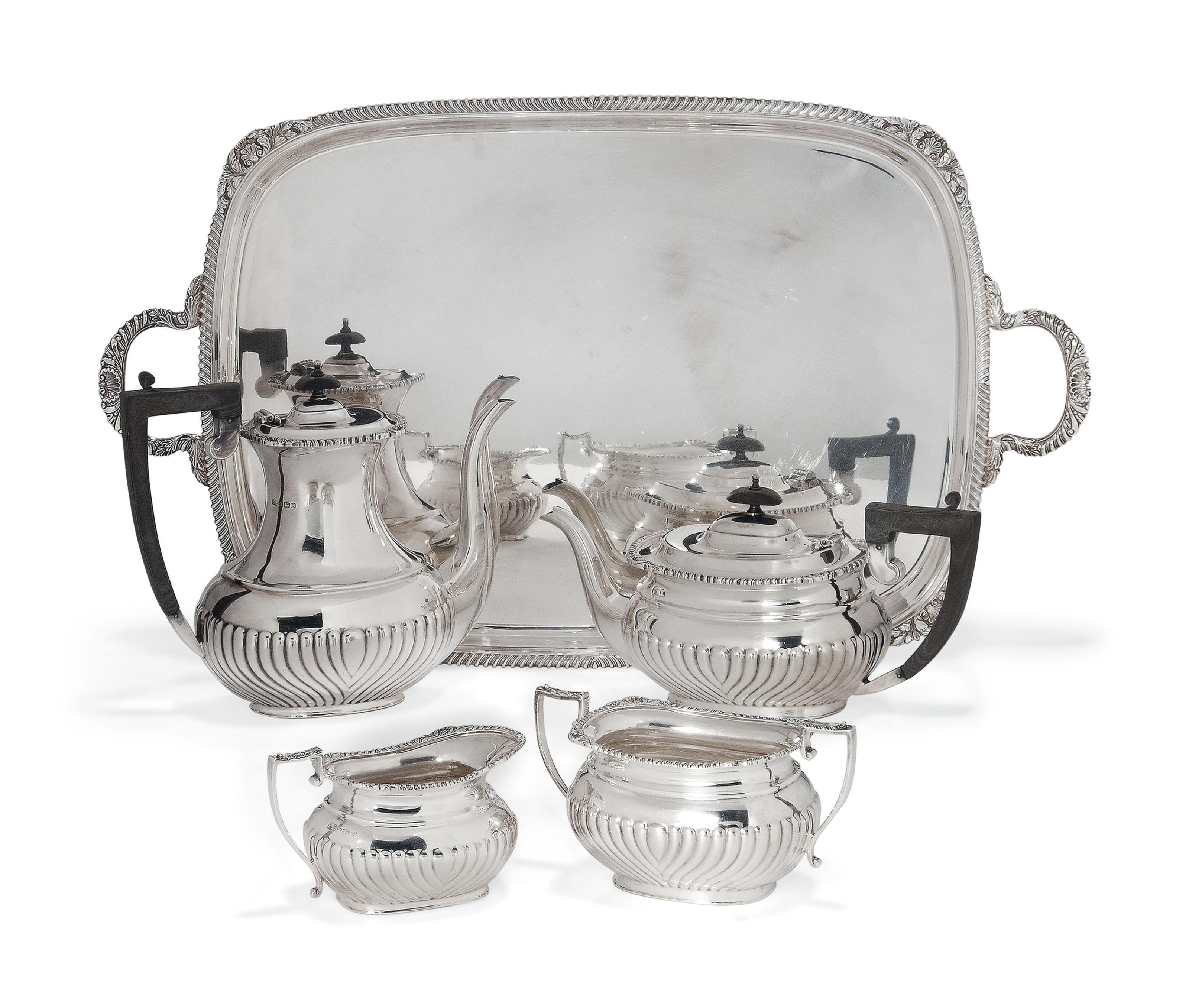 A FOURPIECE SILVER TEA/COFFEE SERVICE AND A BRITANNIA STANDARD SILVER