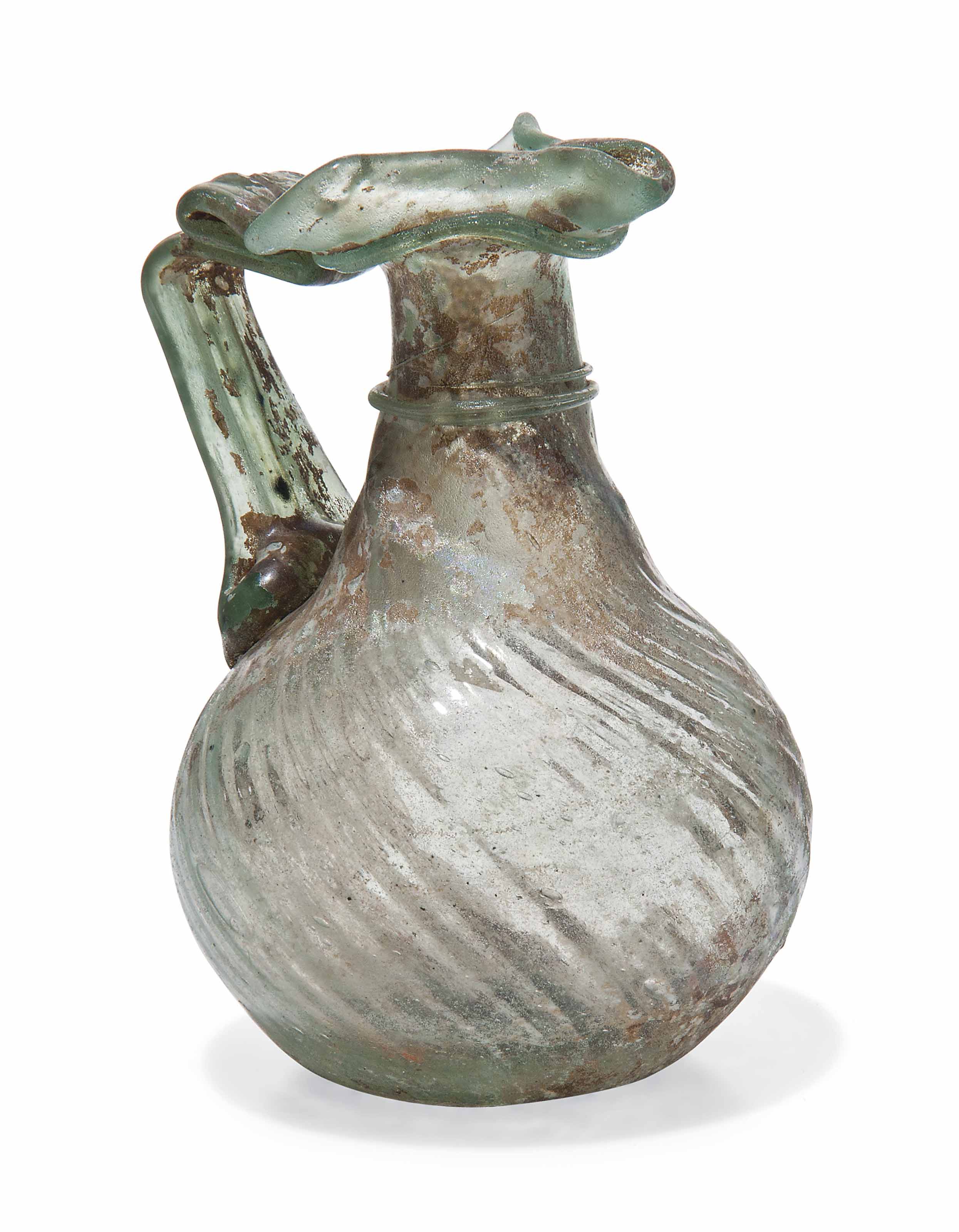 A ROMAN GREEN GLASS JUG , CIRCA 3RD4TH CENTURY A.D. Christie's