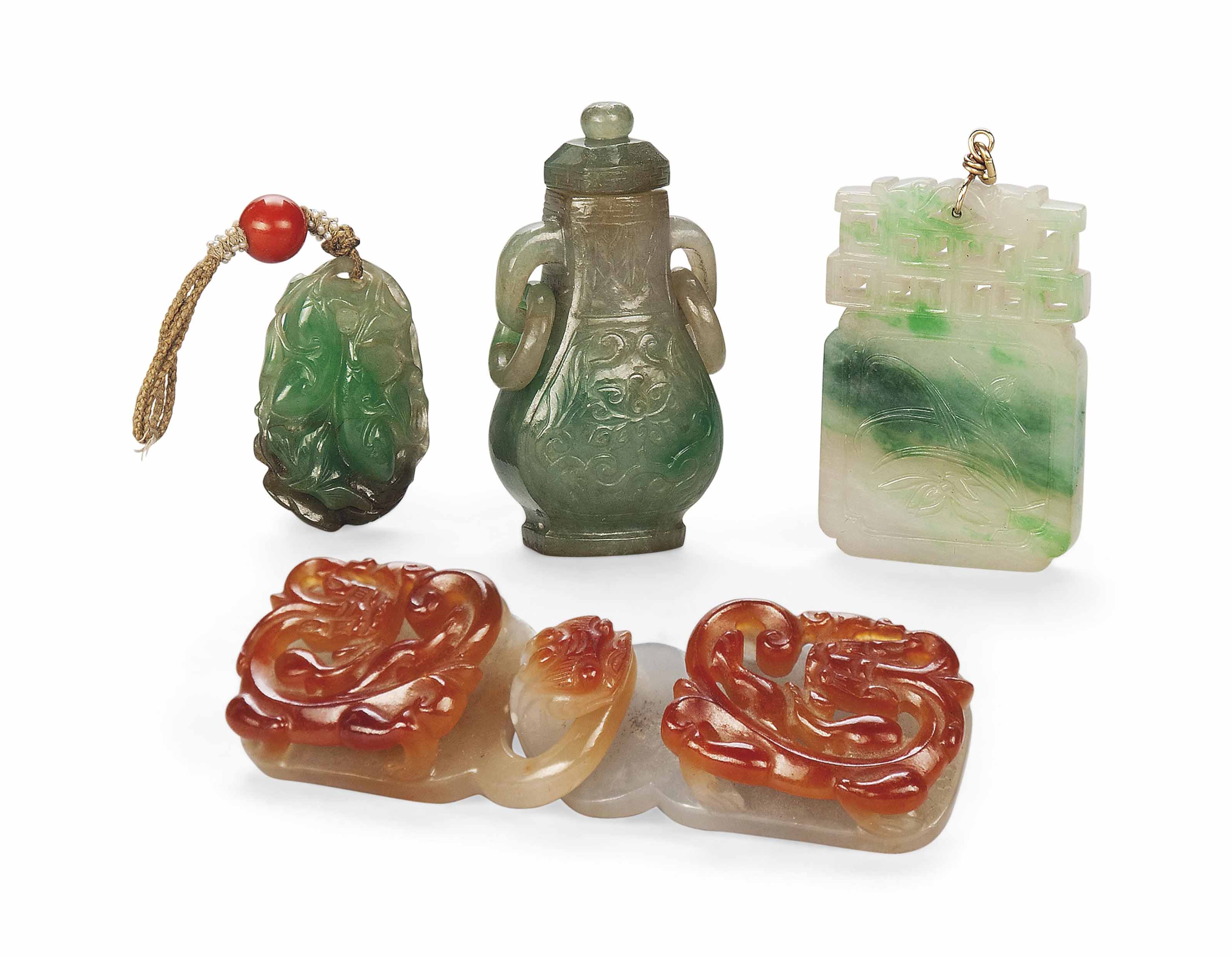 FOUR CARVED AND PIERCED JADEITE CARVINGS