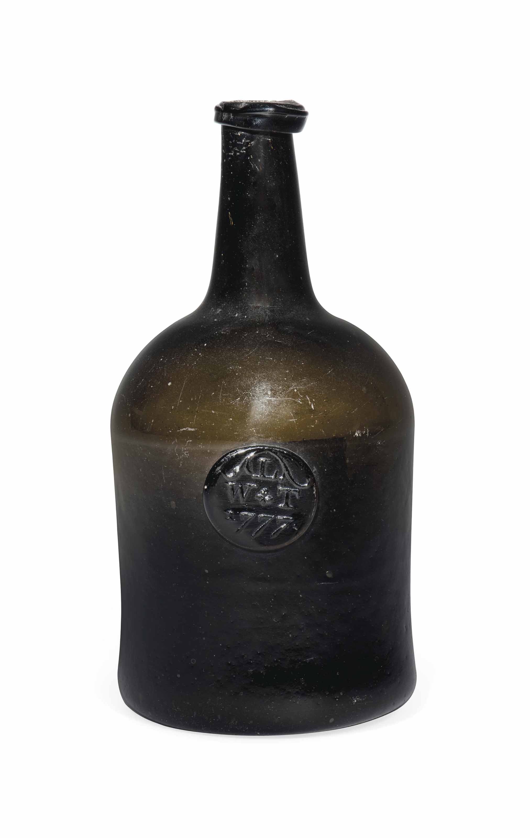 AN ENGLISH SEALED GLASS WINE BOTTLE , DATED 1777 Christie's