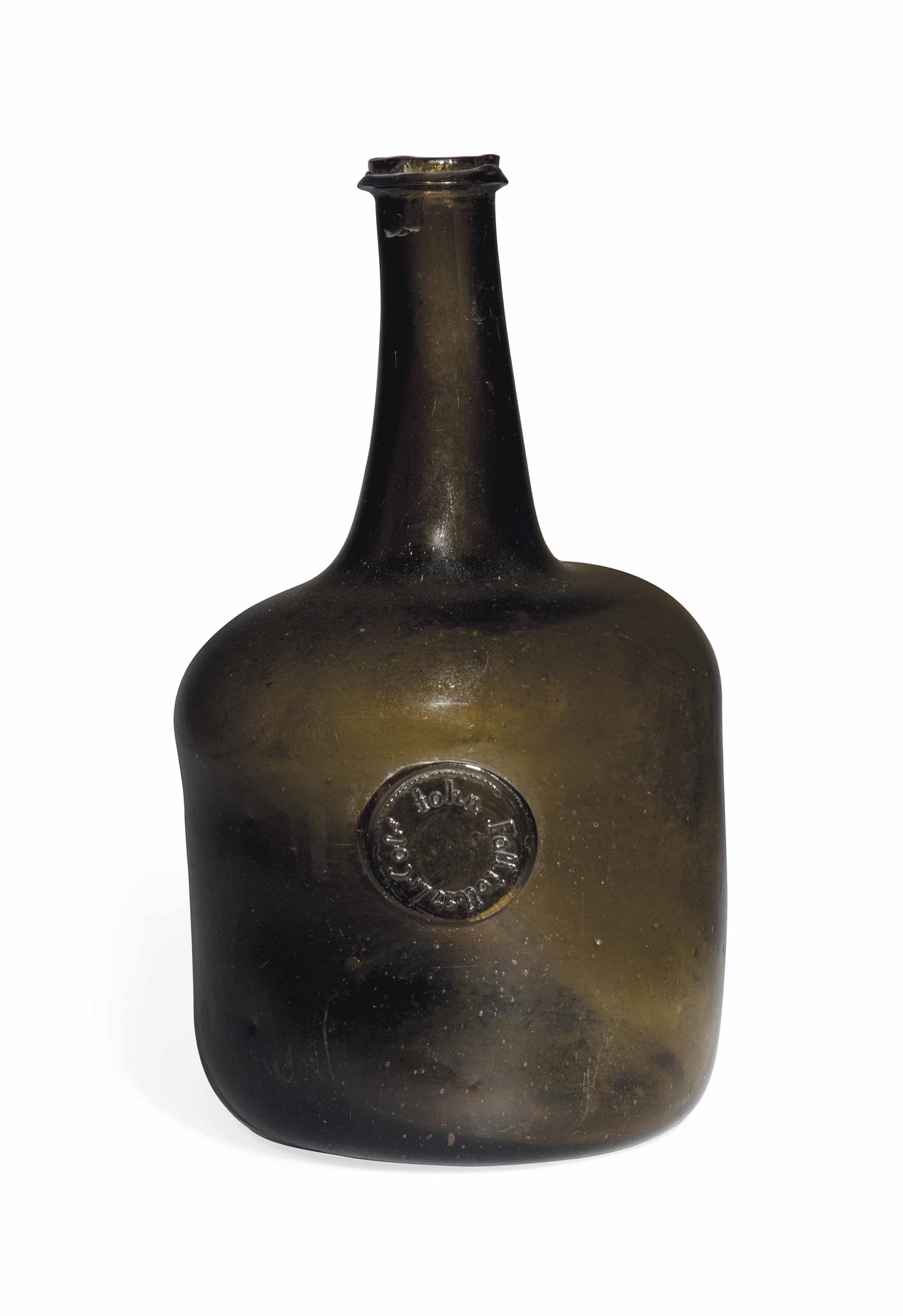 AN ENGLISH GLASS SEALED WINE BOTTLE , DATED 1743 Christie's