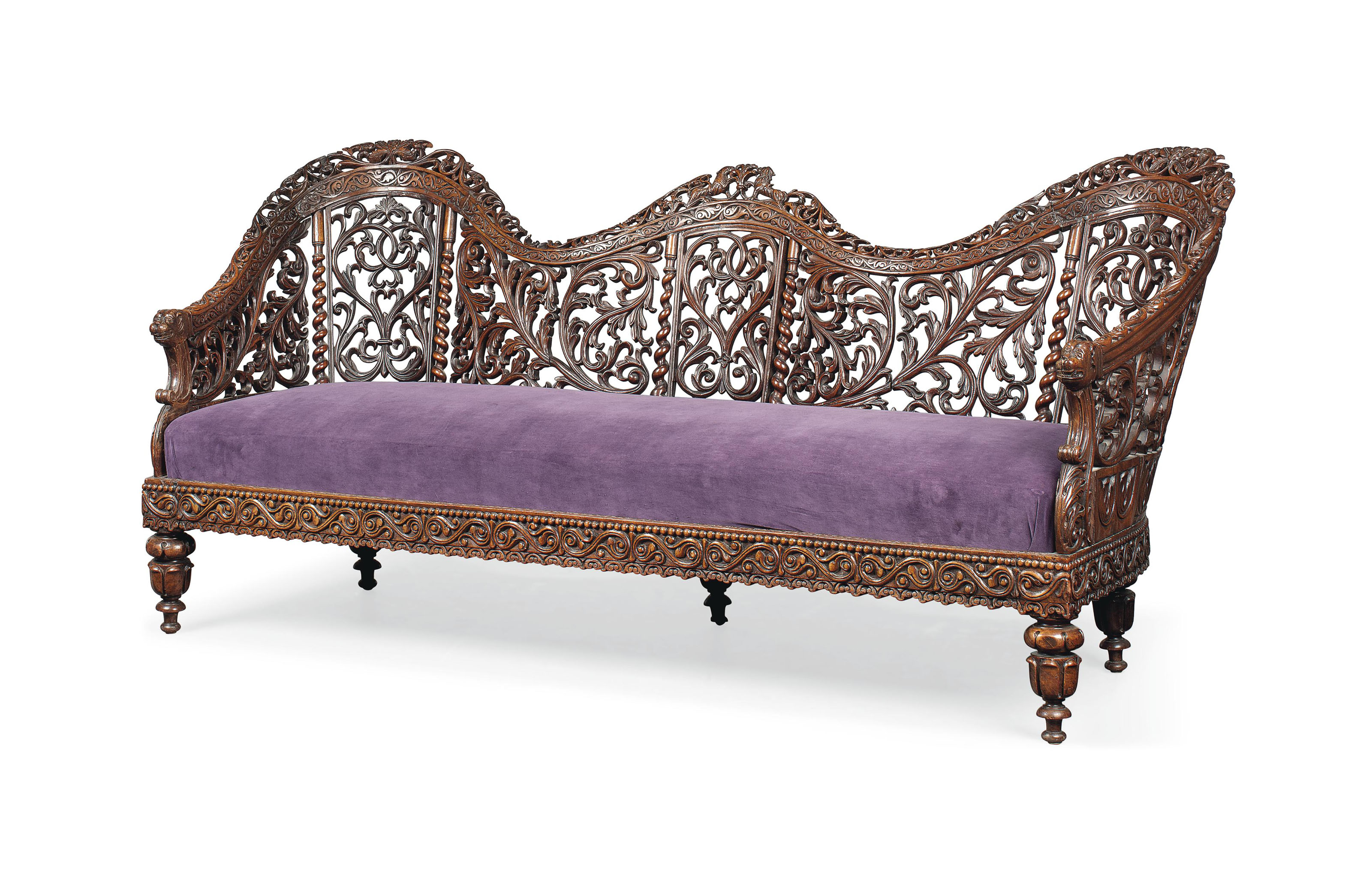 AN ANGLOINDIAN CARVED TEAK SOFA