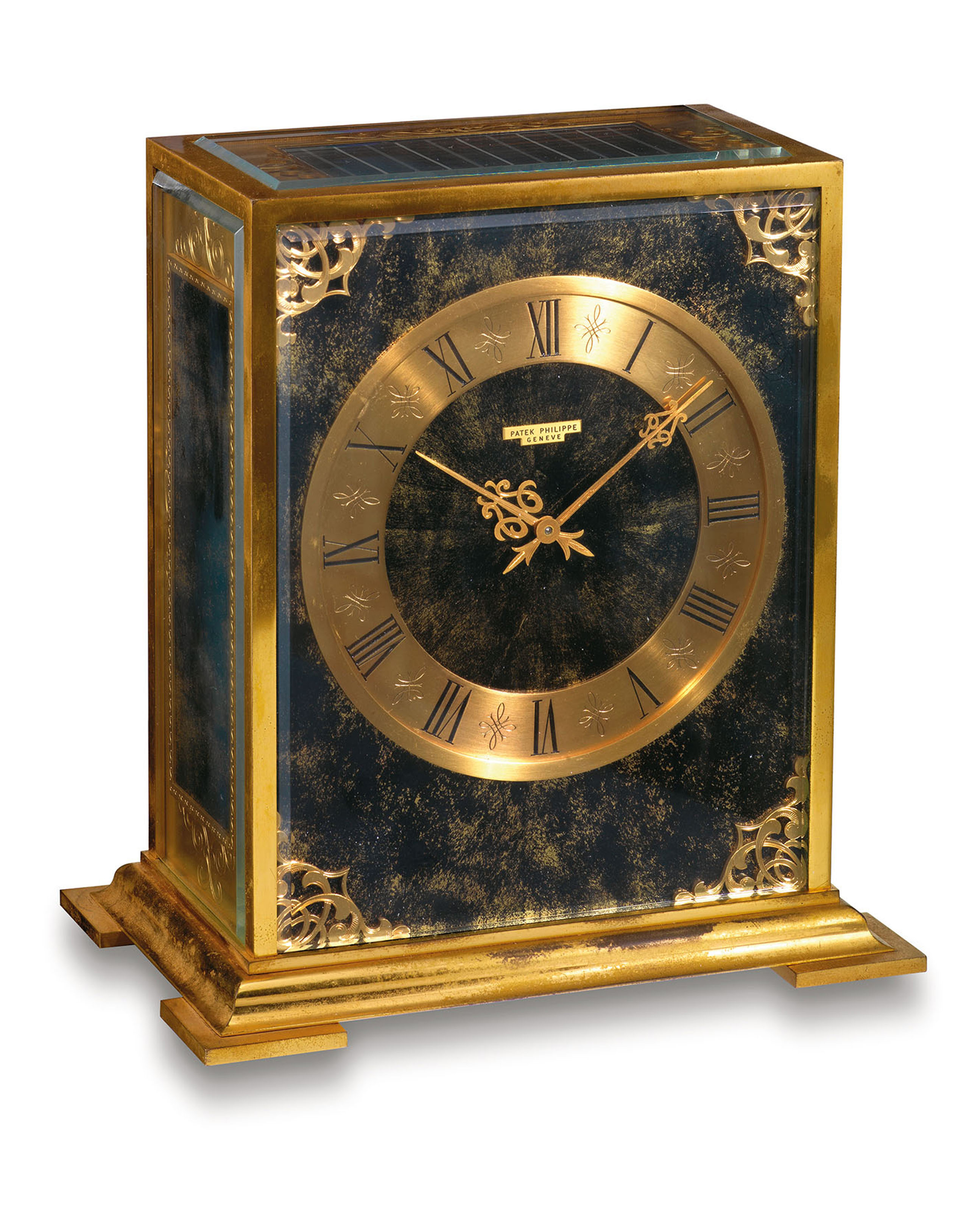 PATEK PHILIPPE. A RARE GILT BRASS RECTANGULAR SOLARPOWERED DESK CLOCK
