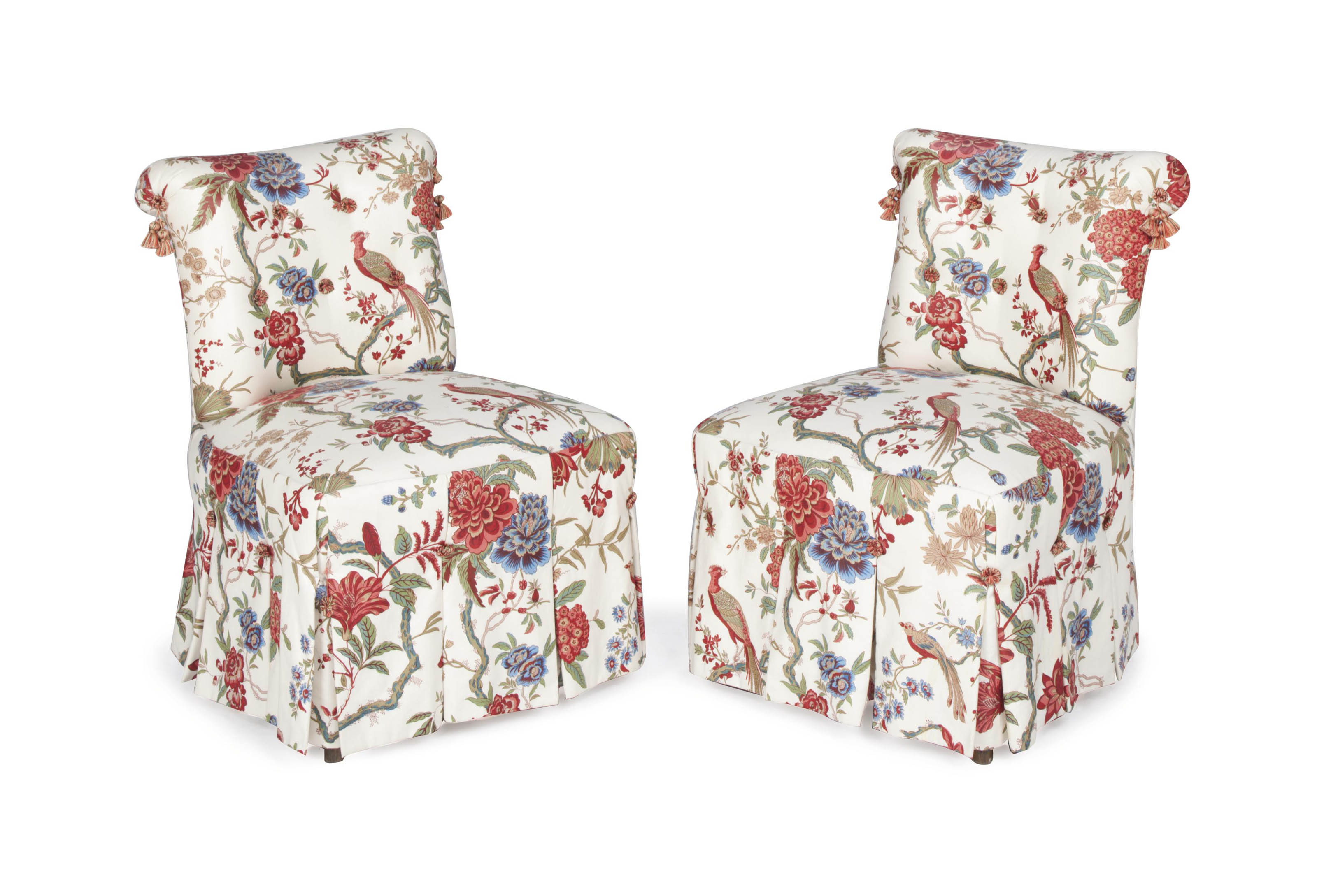 A PAIR OF CREAM GROUND FLORAL CHINTZUPHOLSTERED SLIPPER CHAIRS