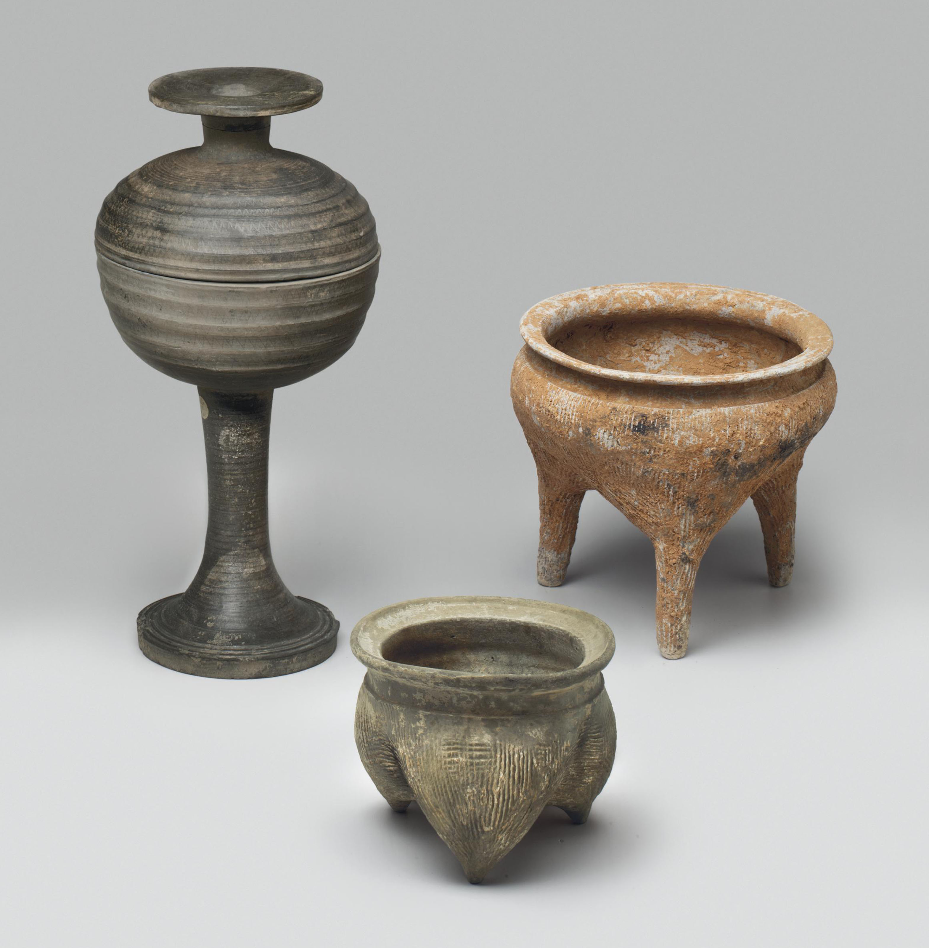 THREE EARLY POTTERY VESSELS , NEOLITHIC/EASTERN ZHOU DYNASTY, 3RD