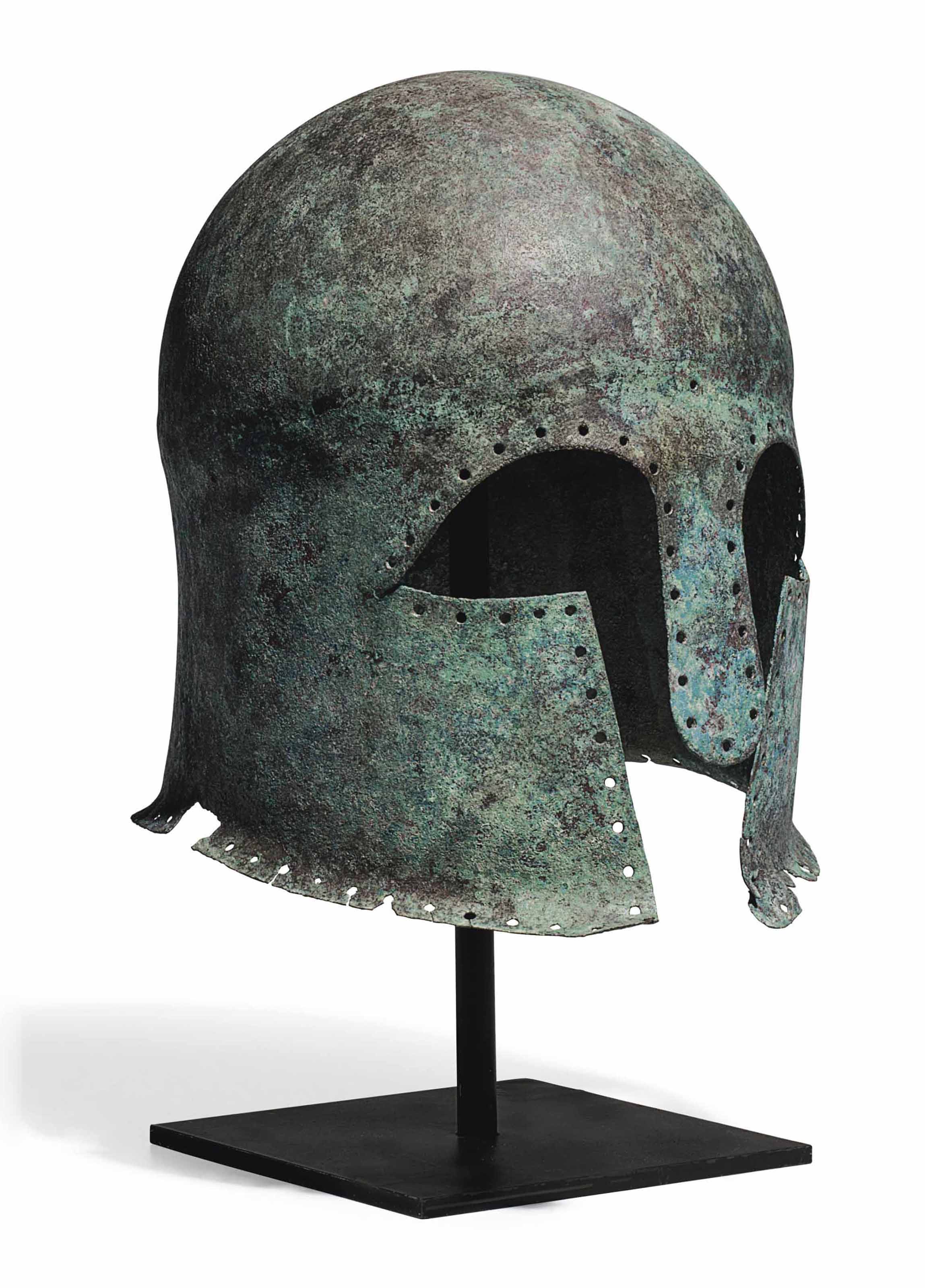 A GREEK BRONZE CORINTHIAN HELMET