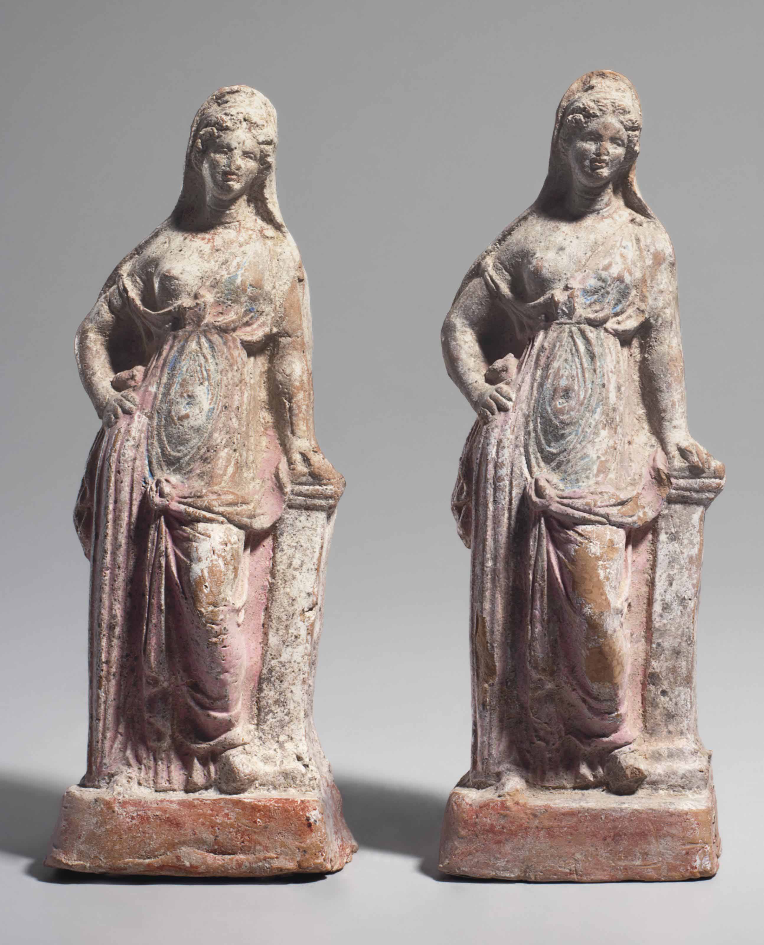 A PAIR OF GREEK TERRACOTTA FEMALE FIGURES , HELLENISTIC PERIOD, CIRCA