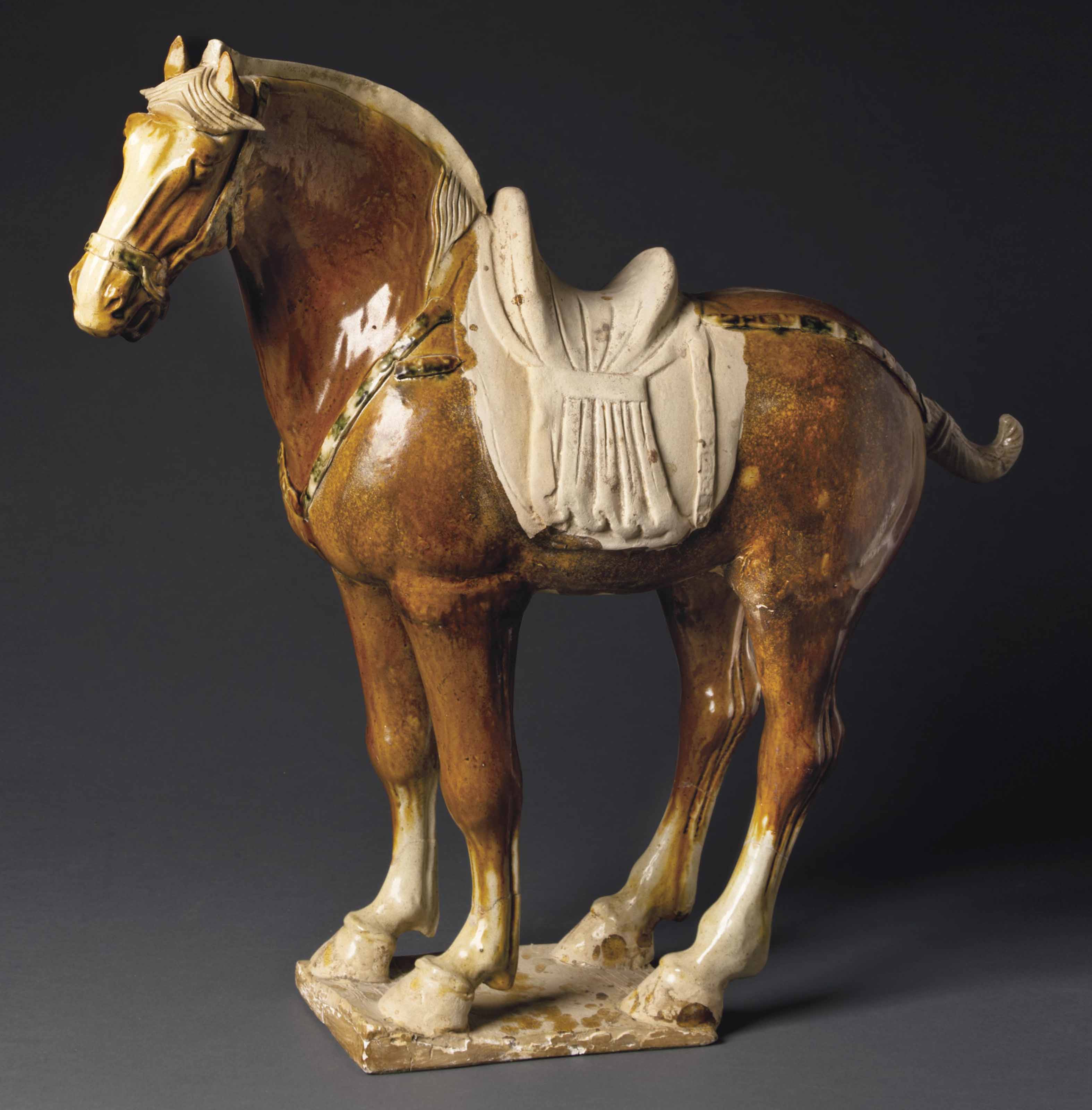 A LARGE SANCAI GLAZED POTTERY FIGURE OF A HORSE , TANG DYNASTY (AD 618