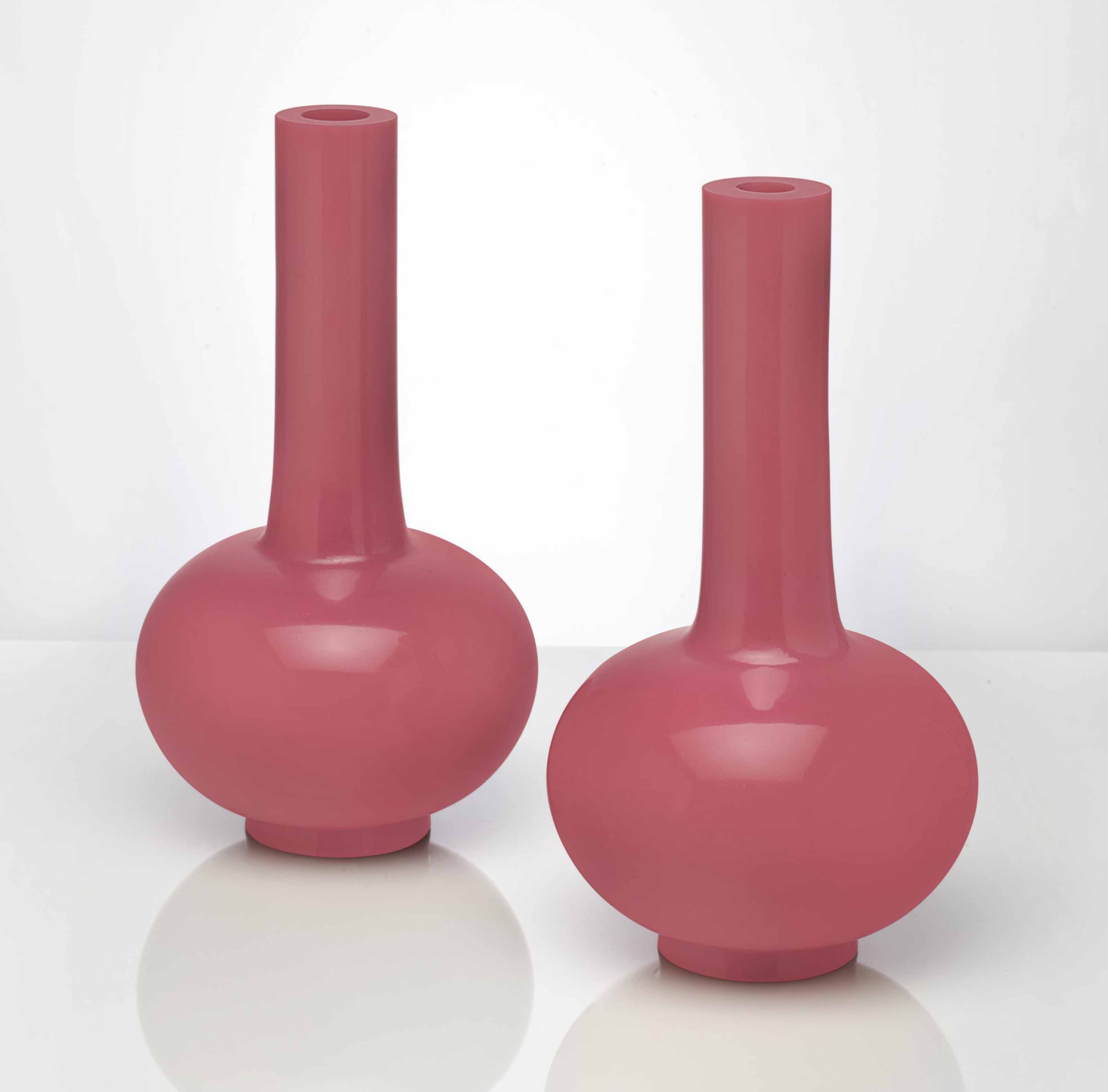 A PAIR OF PINK GLASS BOTTLE VASES