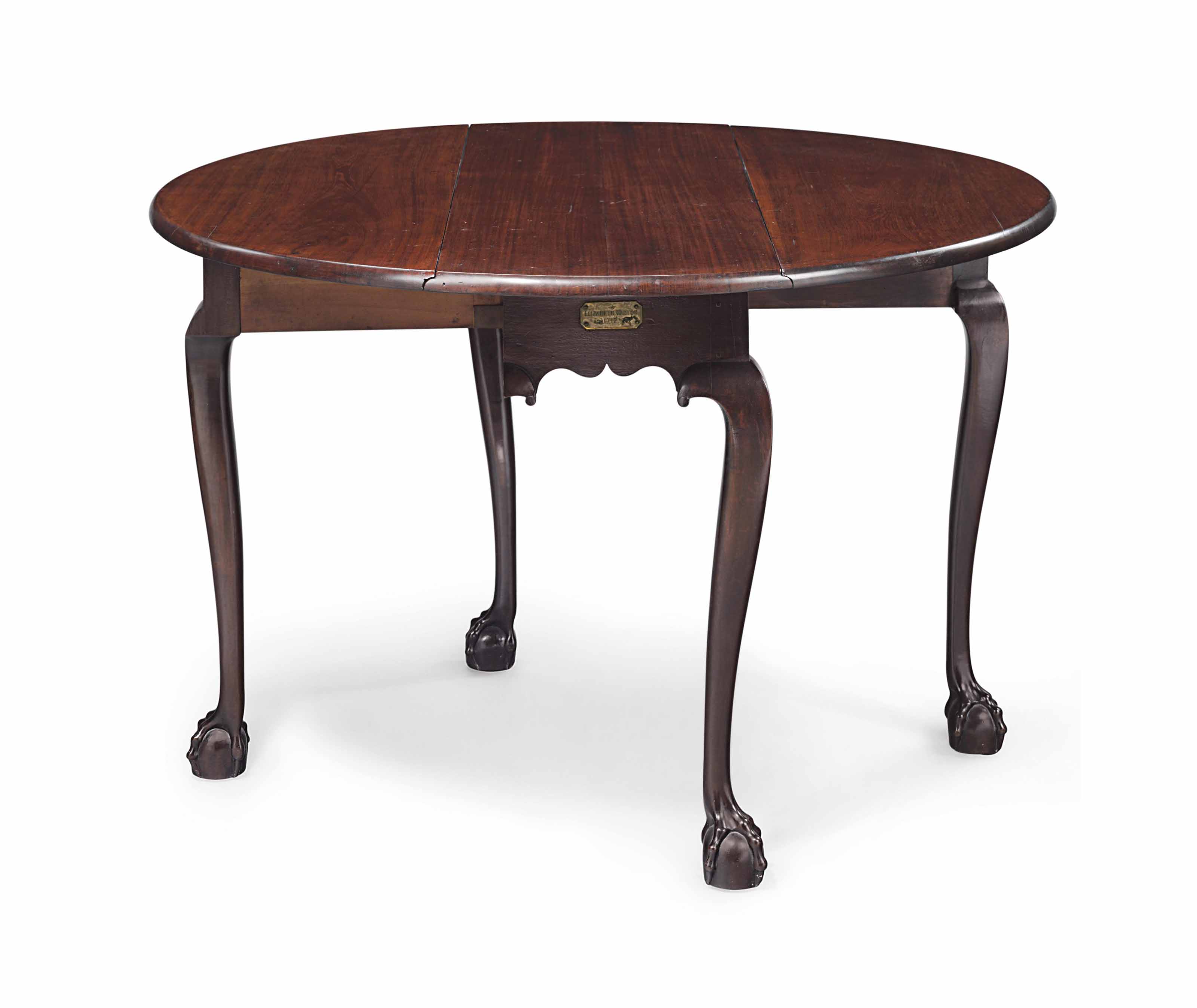 A CHIPPENDALE CARVED MAHOGANY DROPLEAF DINING TABLE