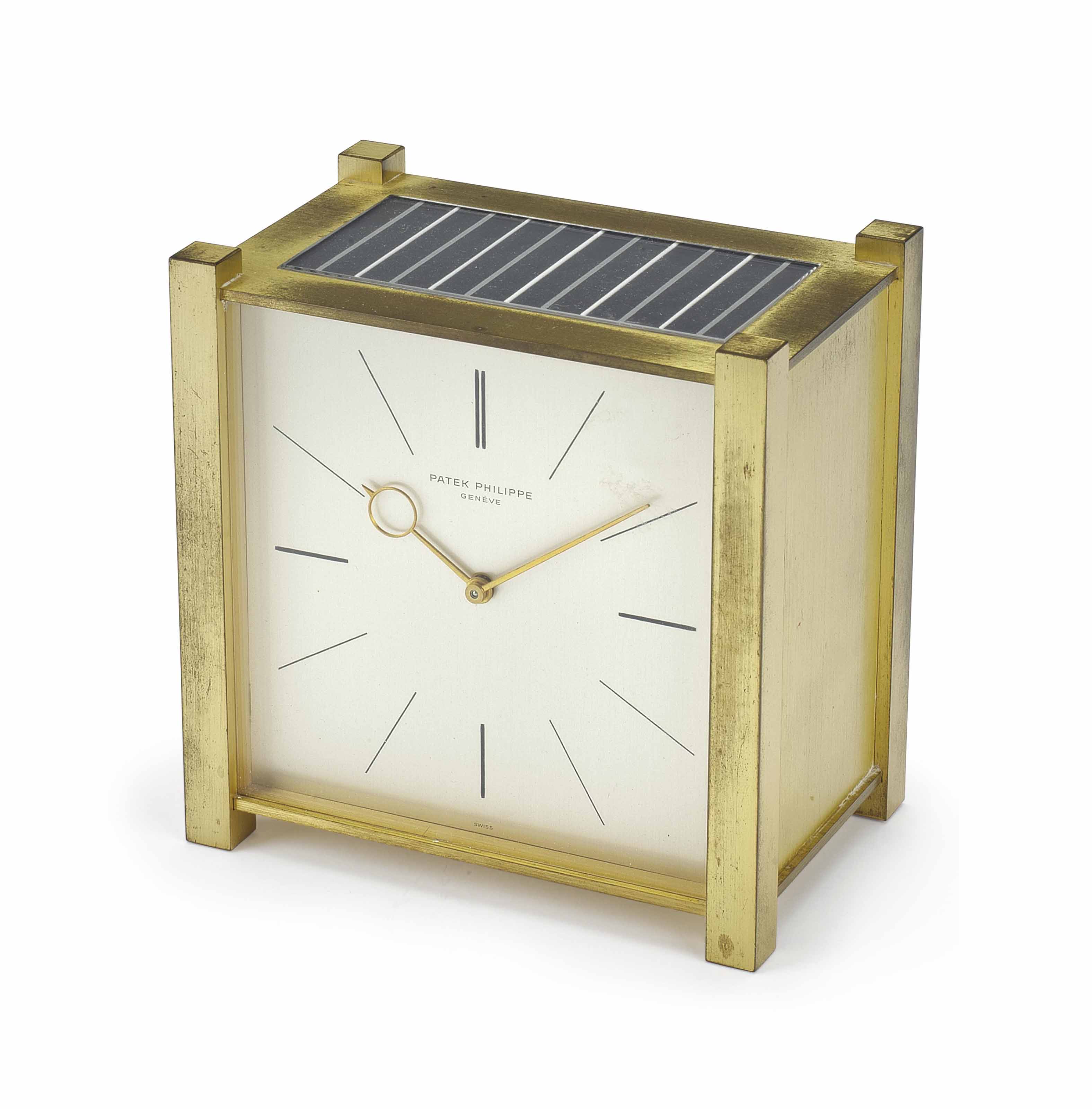 Patek Philippe. A GiltBrass SquareShaped Solar Powered Desk Clock