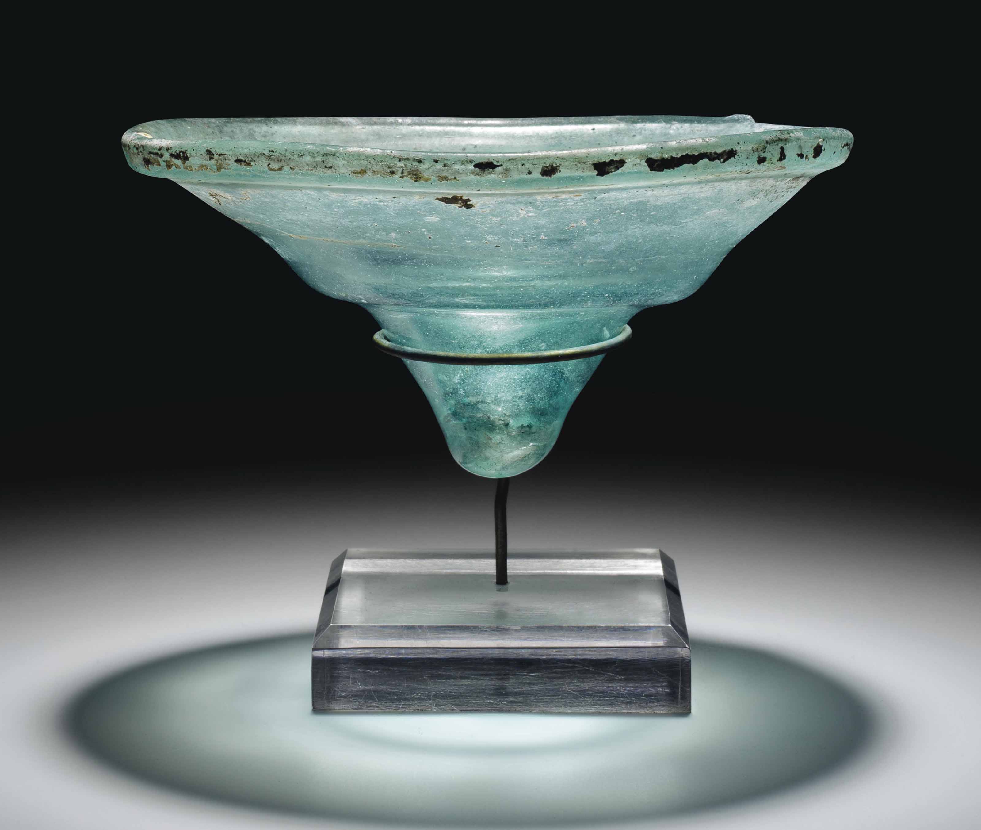A LATE ROMAN GLASS OIL LAMP , CIRCA 4TH CENTURY A.D. Christie's