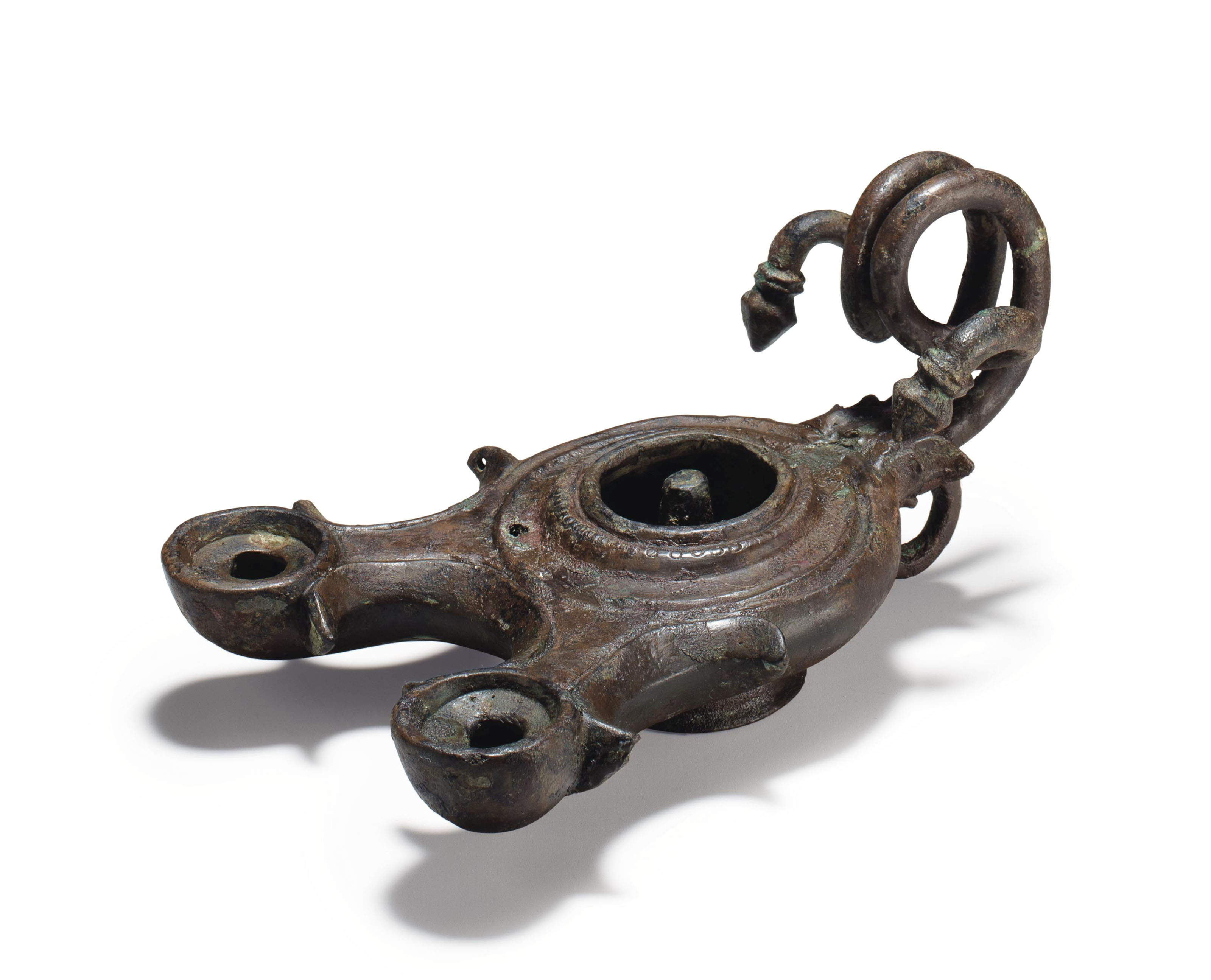 A ROMAN BRONZE OIL LAMP , CIRCA 2ND3RD CENTURY A.D. Christie's