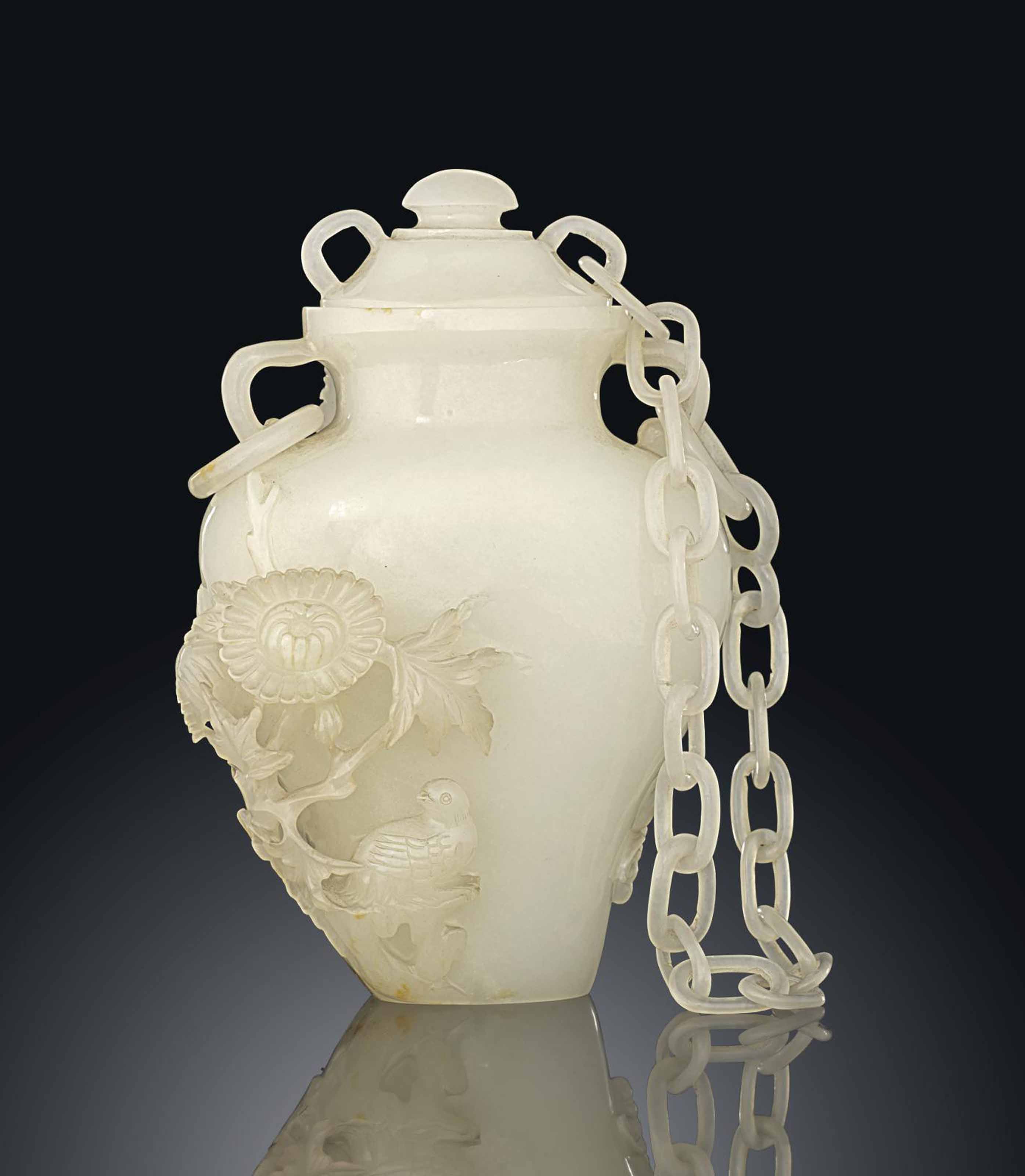 A SMALL CARVED AND PIERCED WHITE JADE VASE AND COVER , JIAQING PERIOD