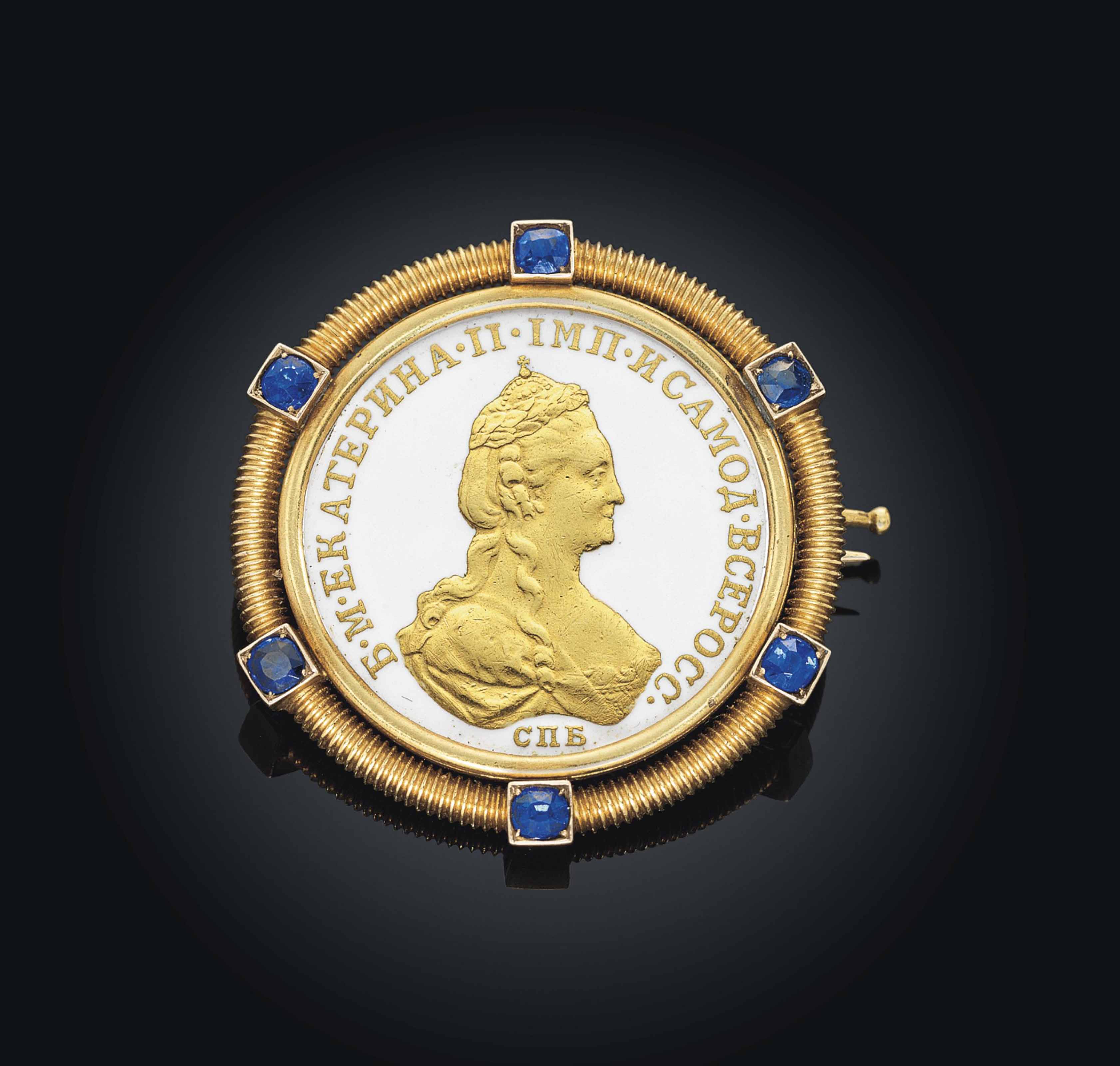 A JEWELLED GOLDMOUNTED AND EN PLEIN ENAMEL COIN BROOCH