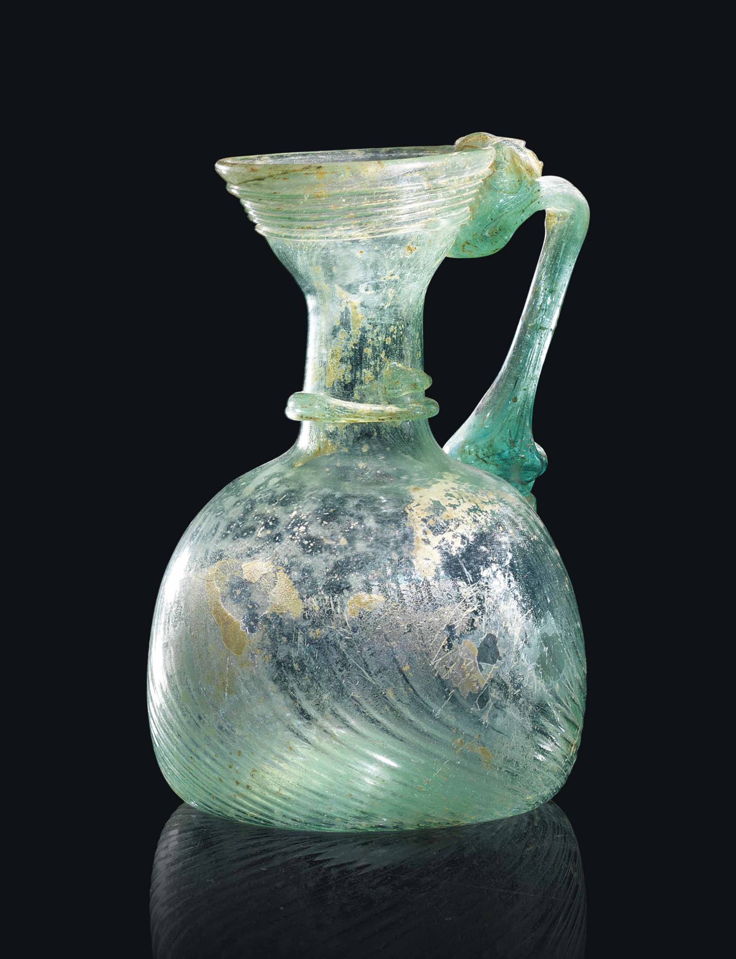 A ROMAN GREEN GLASS JUG , CIRCA 4TH5TH CENTURY A.D. Christie's