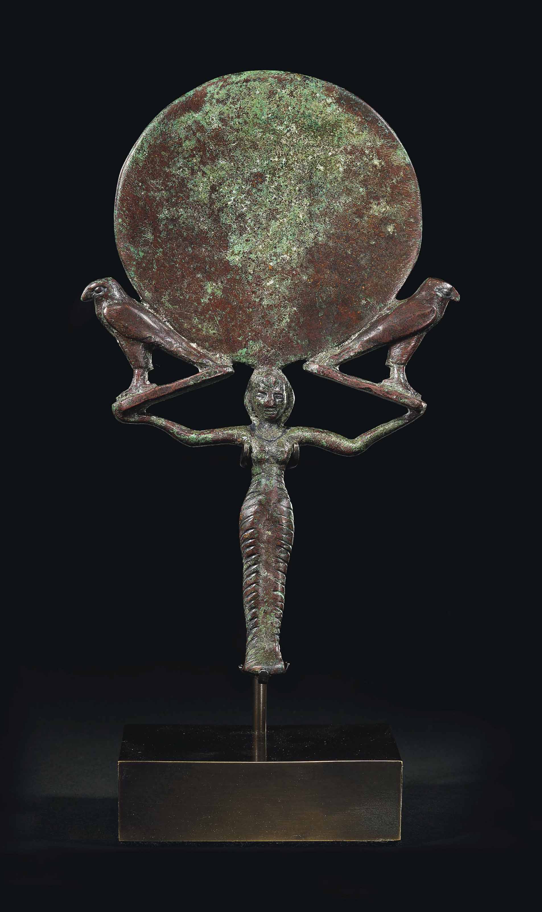 AN EGYPTIAN BRONZE MIRROR , MIDDLE KINGDOM, CIRCA 2040-1750 B.C