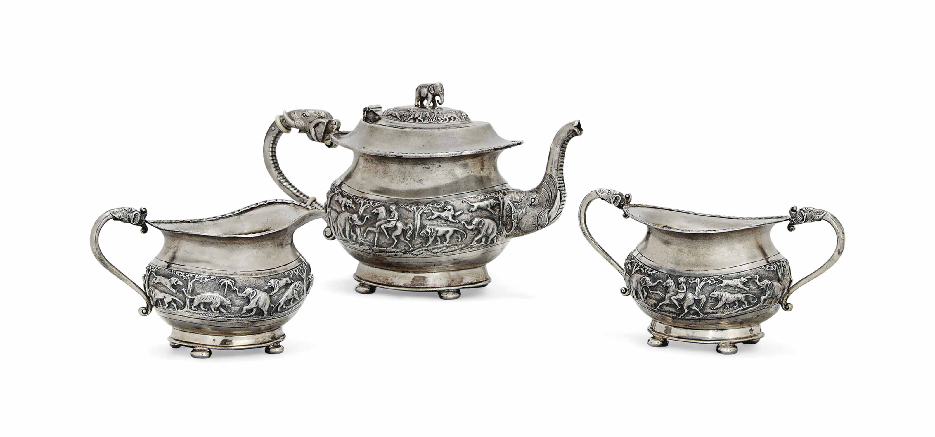 A THREEPIECE REPOUSSÉ SILVER GILT TEA SET , BOMBAY, INDIA, LATE 19TH