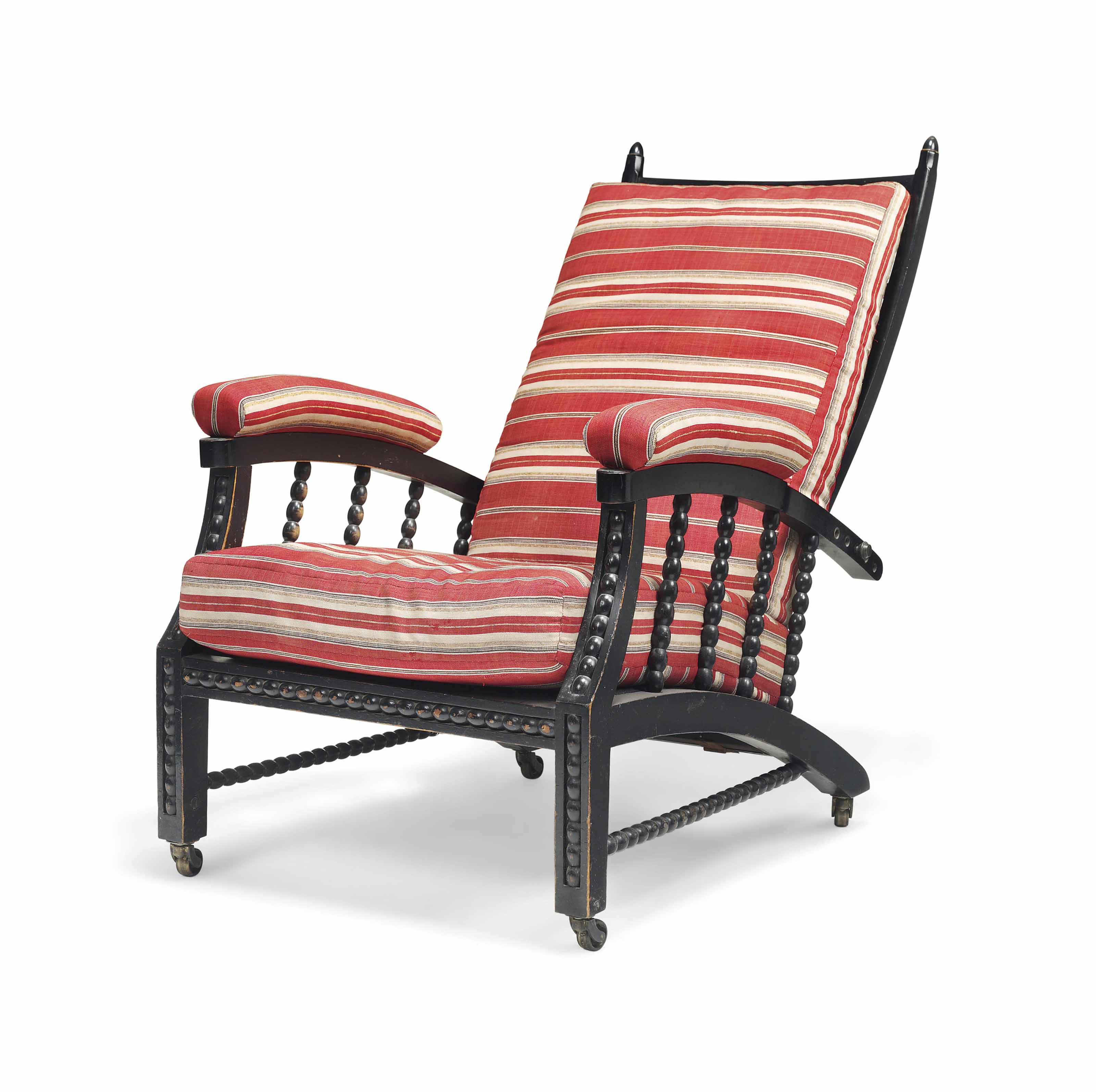 AN ARTS AND CRAFTS EBONISED RECLINING ARMCHAIR , DESIGNED BY PHILIP WEBB FOR MORRIS, MARSHALL
